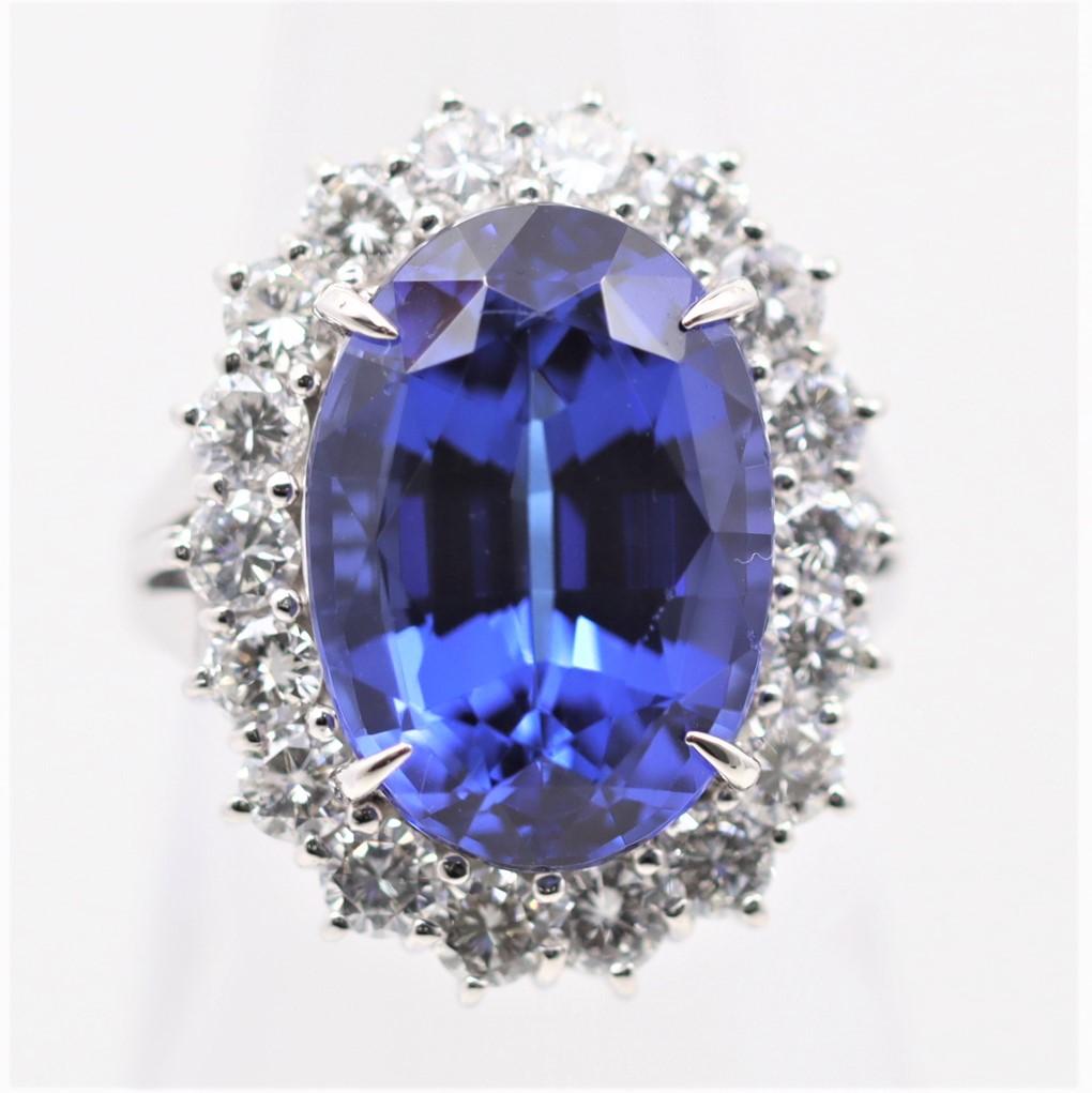 A large and immensely fine tanzanite, weighing an impressive 10.98 carats, takes center stage of this fine platinum ring. The tanzanite has a lovely oval-shape and an even better pure vivid blue color that rivals the finest sapphires. It is