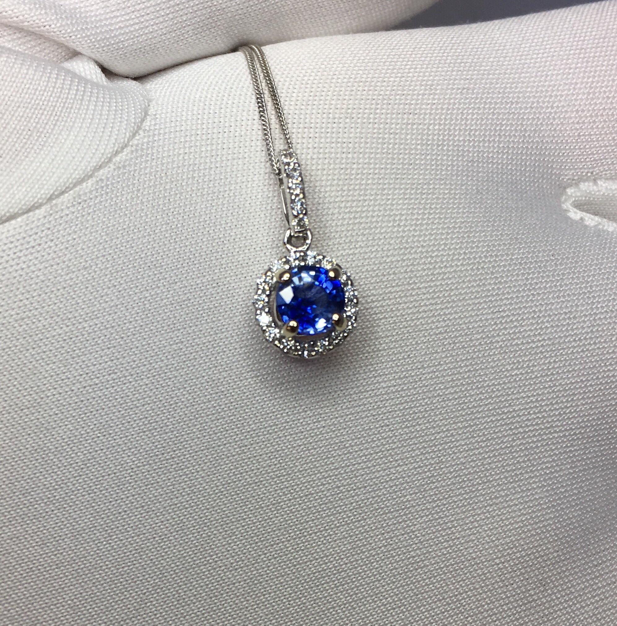 Stunning natural vivid blue Ceylon sapphire set in a fine 18k white gold diamond cluster Pendant. 

0.60 carat centre sapphire with stunning blue colour and very good clarity.
Ceylon in origin, source of some of the worlds best quality