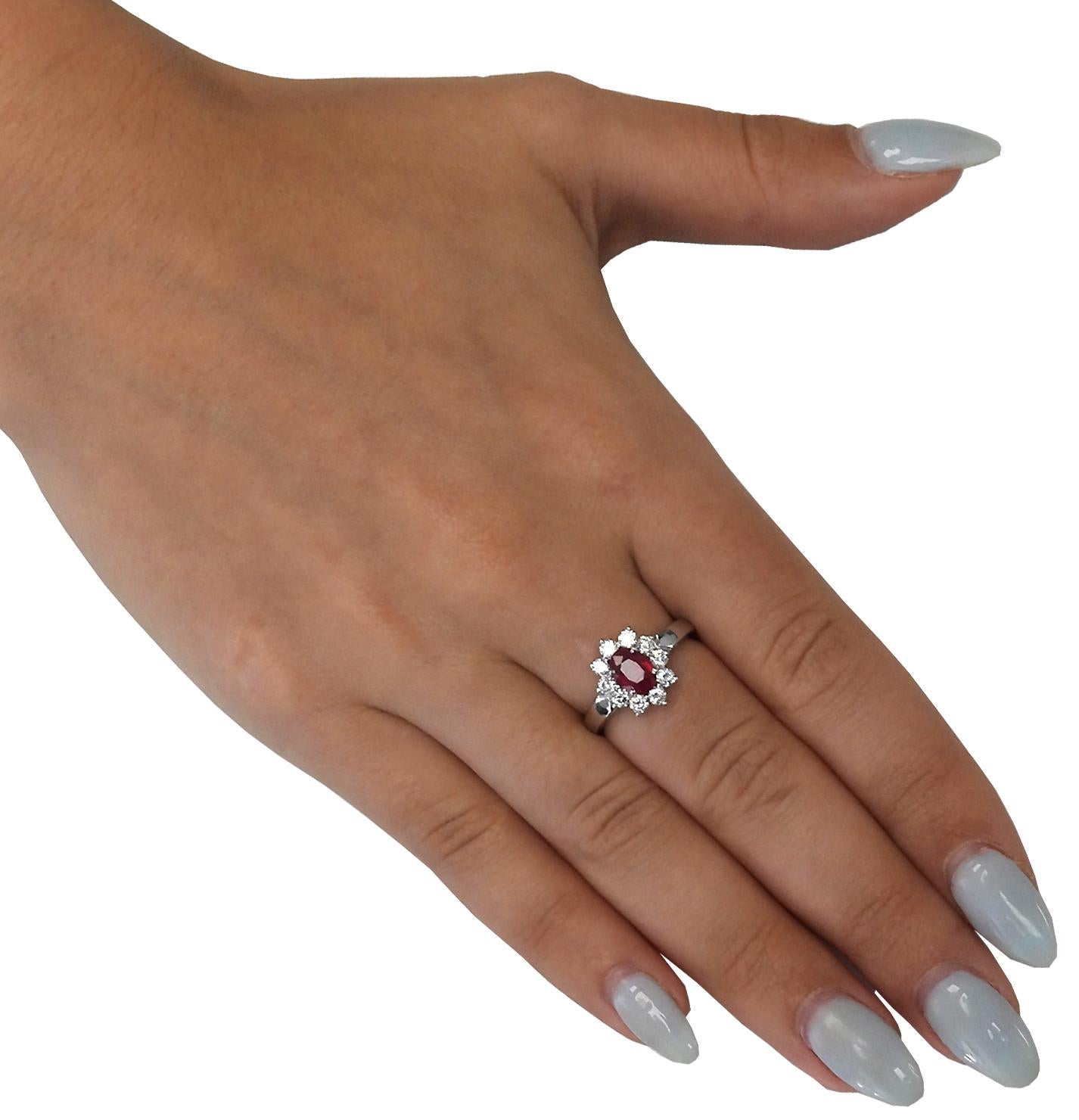 Sensational Vivid Diamonds ring finely crafted by hand in platinum, featuring an oval cut Burma Ruby weighing 0.89 carats total accompanied by 10 round brilliant cut diamonds weighing approximately 0.68 carats total, F color, VS clarity, seamlessly