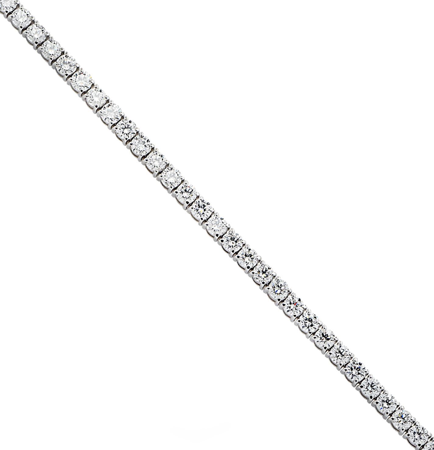 Exquisite diamond tennis bracelet crafted in 18 karat white gold, showcasing 42 stunning round brilliant cut diamonds weighing 10.03 carats total, F-G color, SI clarity. Each diamond is carefully selected, perfectly matched and set in a seamless