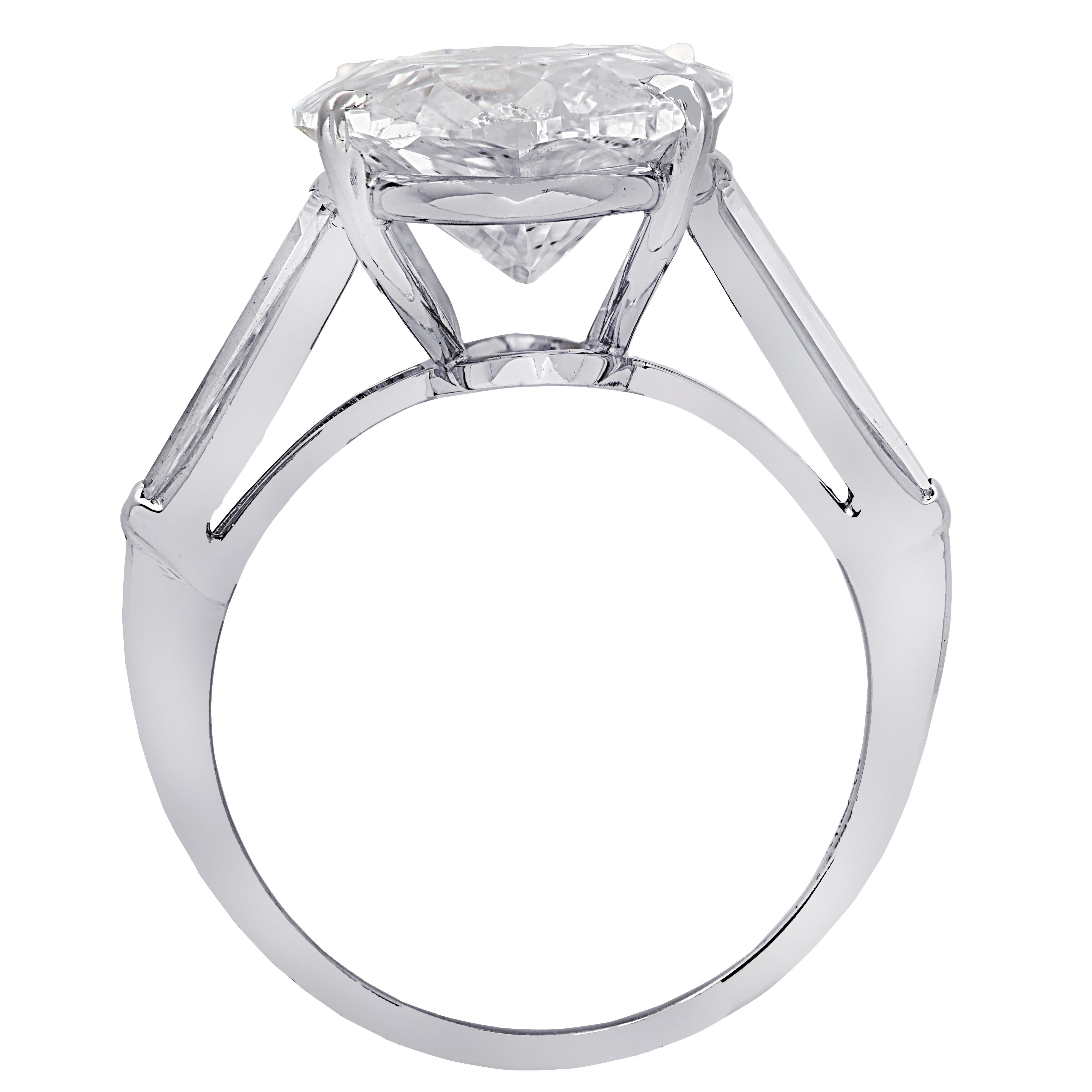 Exquisite Vivid Diamonds engagement ring crafted in platinum, showcasing a sensational moval cut diamond weighing 10.14 carats, D color, I1 clarity, accompanied by 2 carefully selected and perfectly matched tapered baguettes weighing approximately 1