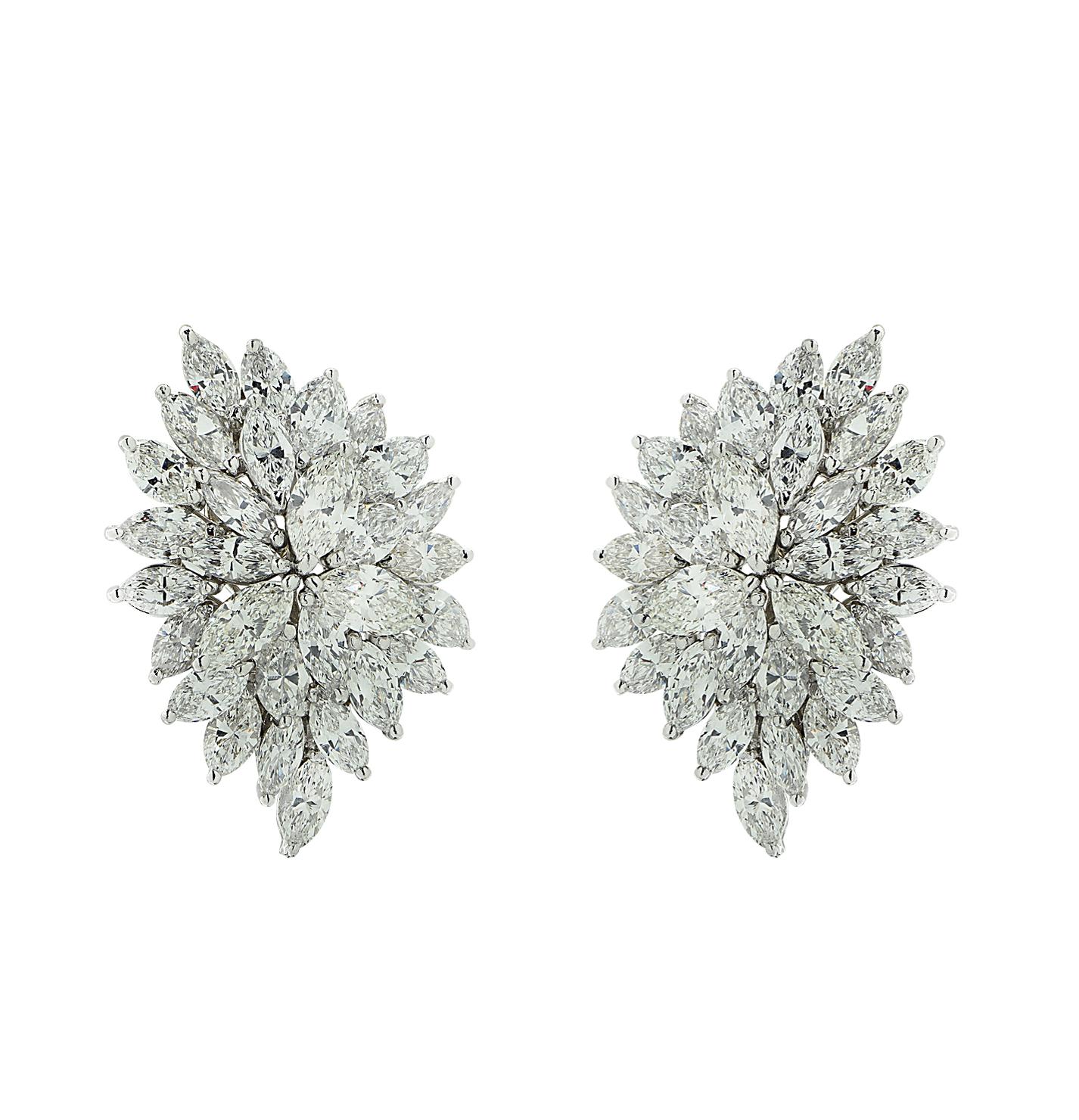 Exquisite diamond earrings finely crafted in 18 karat white gold, showcasing 56 marquise cut diamonds weighing approximately 12.70 carats total, F-J color, VS clarity. The earrings are fashioned into clusters adorned with diamonds, capturing the