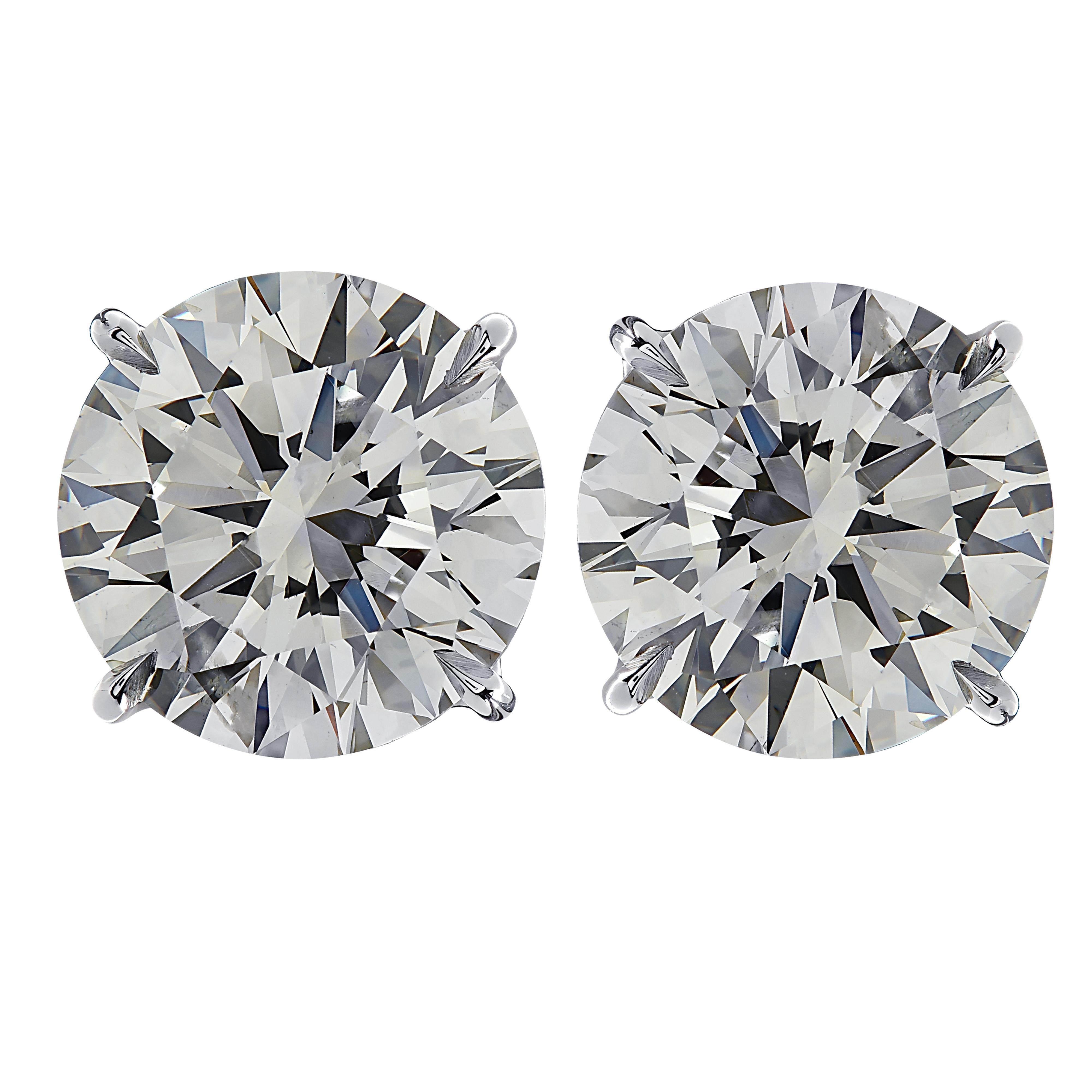 Stunning Vivid Diamonds solitaire stud earrings crafted in 18 karat white gold, showcasing 2 spectacular round brilliant cut diamonds weighing 15.77 carats total, K-L color and VS1-SI2 clarity. These diamonds were carefully selected and perfectly