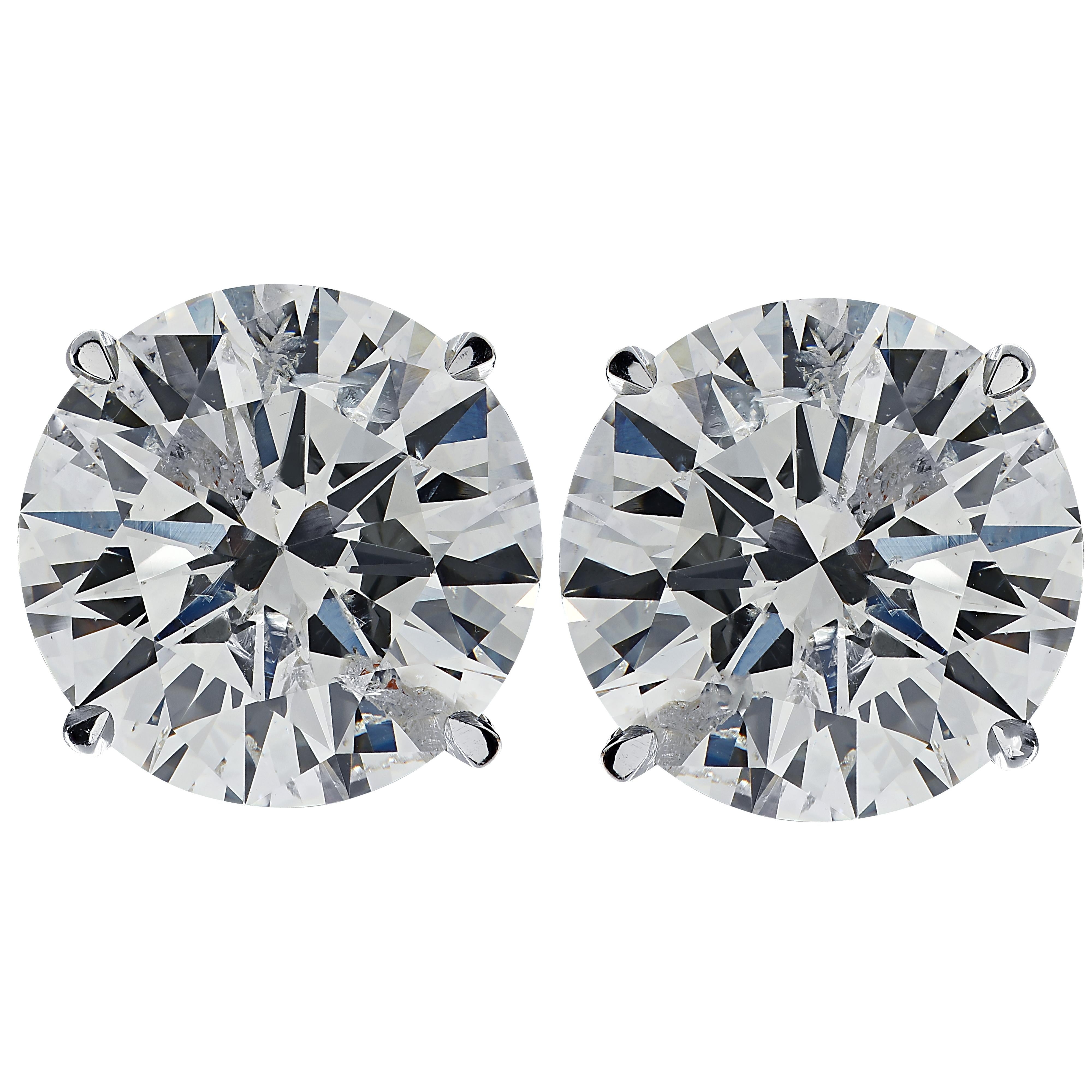 Stunning Vivid Diamonds solitaire stud earrings crafted in 18 karat white gold, showcasing 2 spectacular round brilliant cut diamonds weighing 1.93 carats total, H-I color an I1 clarity. These diamonds were carefully selected and perfectly matched