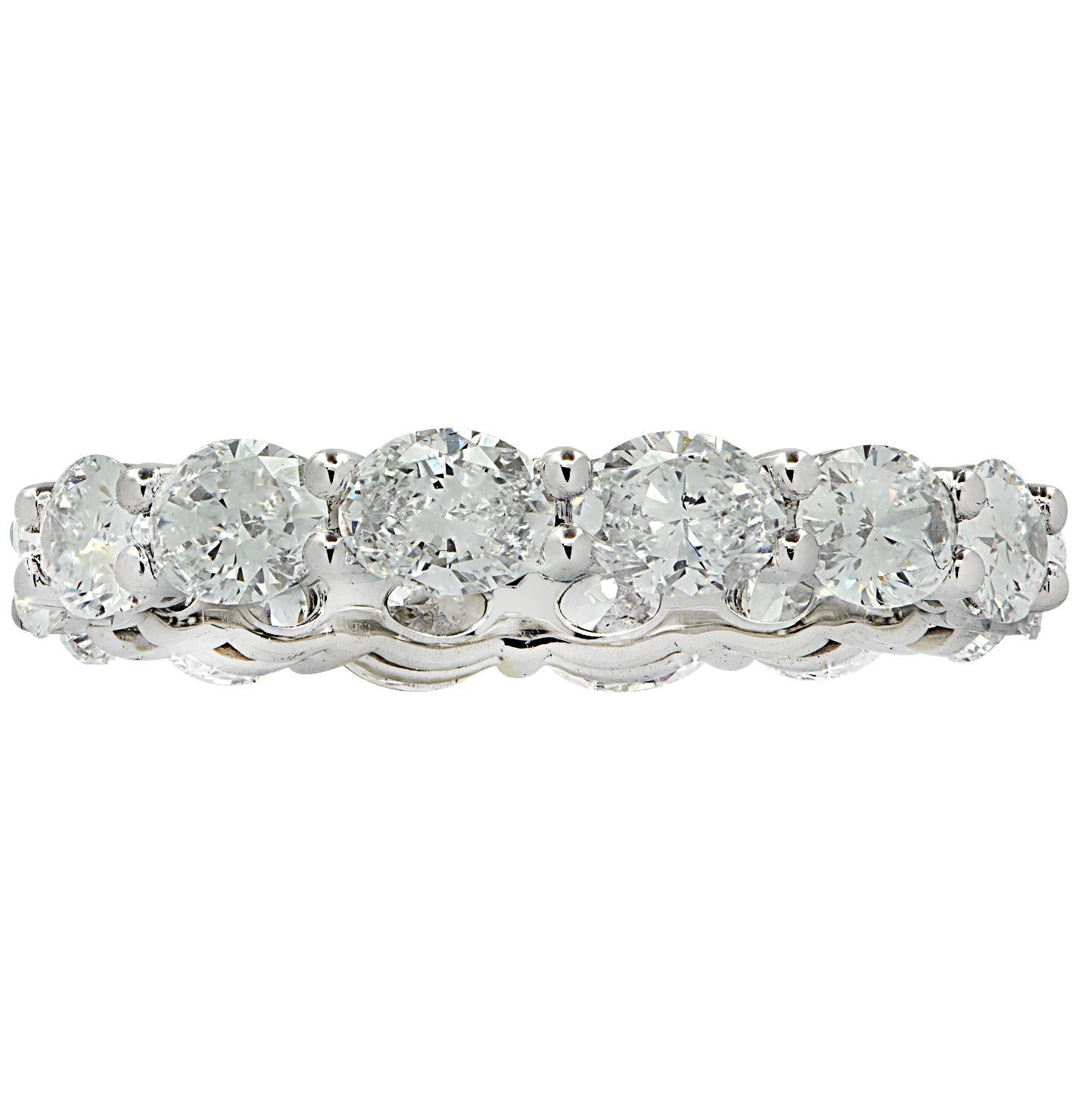 Stunning Vivid Diamonds East-West Eternity Band crafted in 18 karat White Gold, featuring 14 oval cut diamonds weighing 2.60 carats total, D-E color, VVS clarity. These fine diamonds are seamlessly set, east-west, in a modern take on the classic