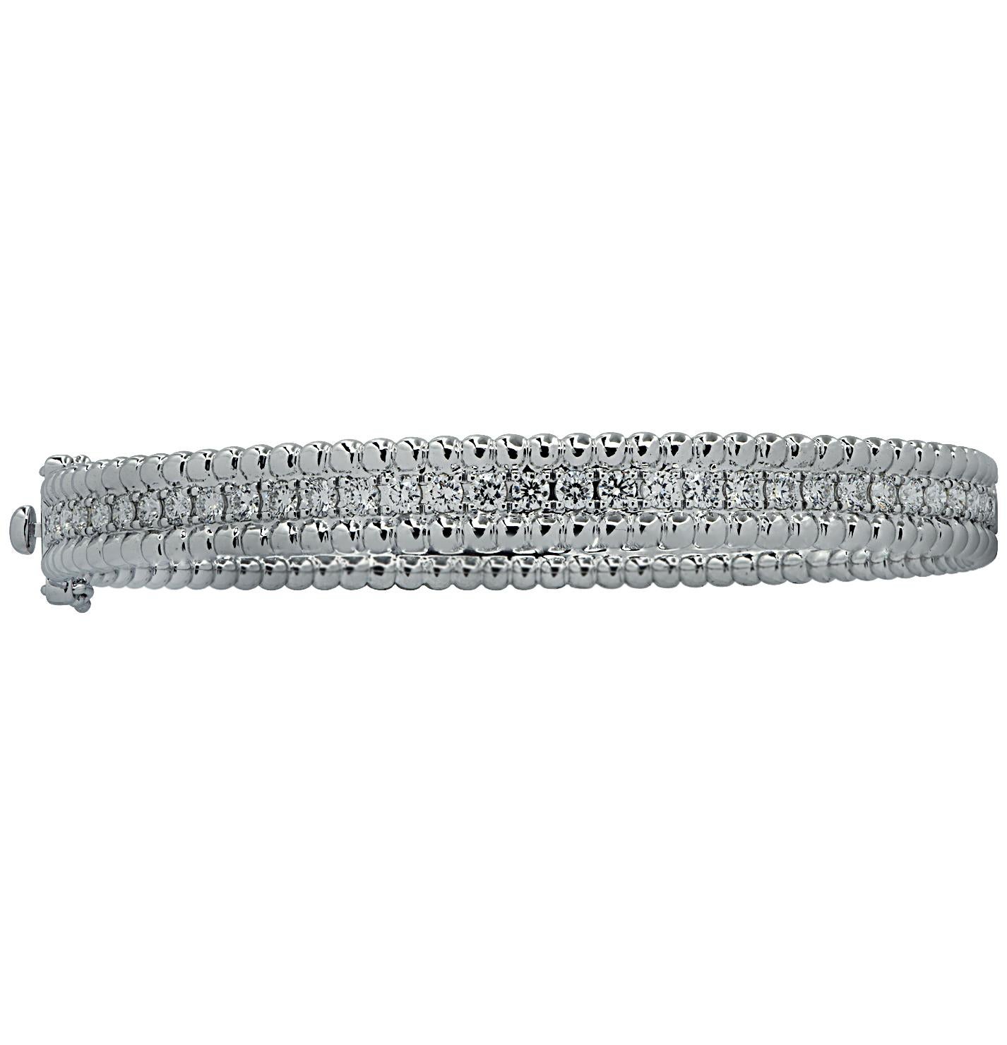 Stunning Vivid Diamonds Bangle Bracelet crafted in white gold, featuring 64 round brilliant cut diamonds weighing 2.79 carats total, F color, VS-SI clarity. This spectacular bangle is set with a row of diamonds, laced with gold beads creating a