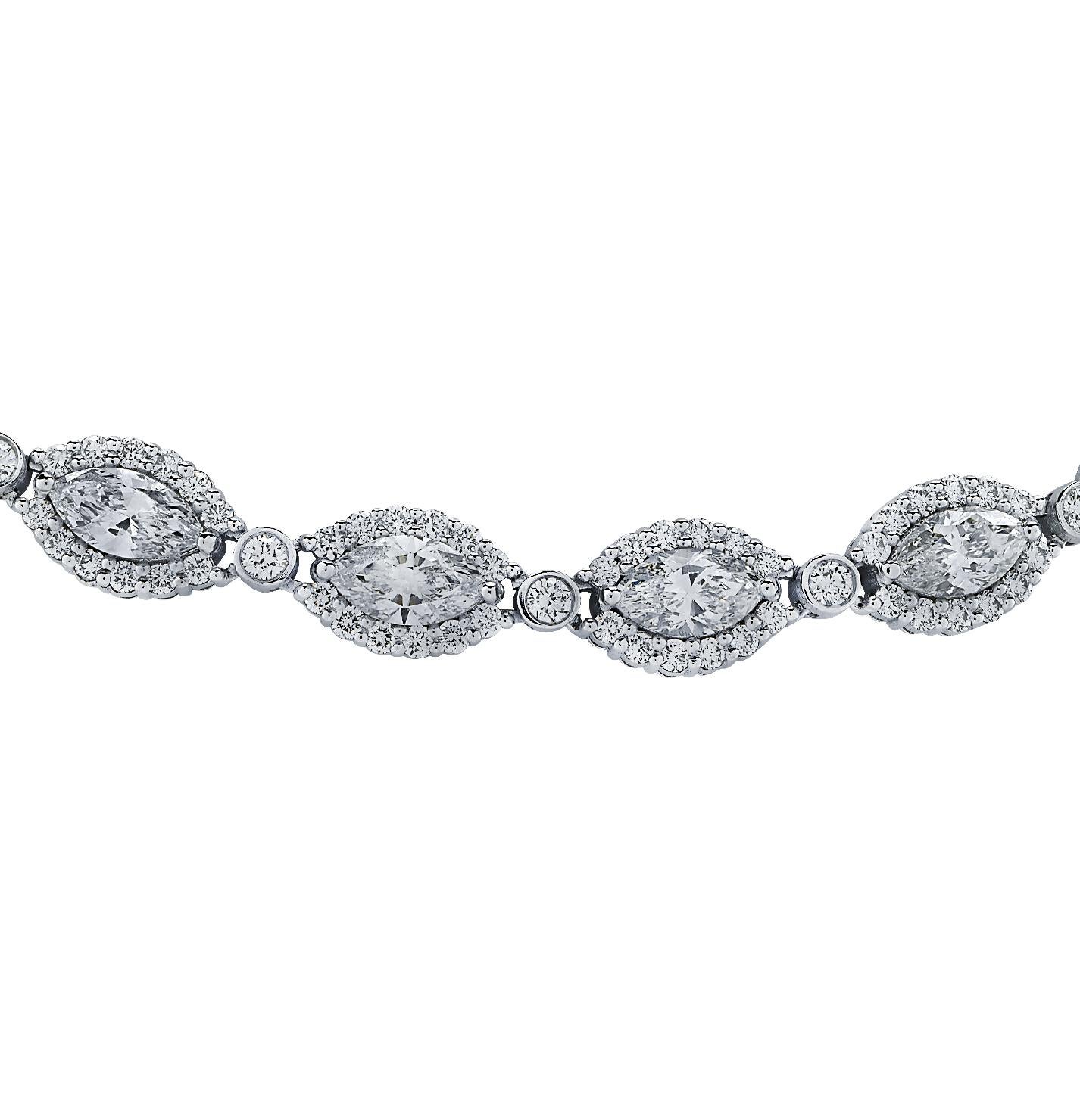 A luxurious necklace, creating striking constellation of light all throughout. Crafted in platinum, and an assemblage of 33 marquise diamonds, weighing approximately 19.63 carats total, J color, VS-SI clarity, each haloed with 12 round diamonds and