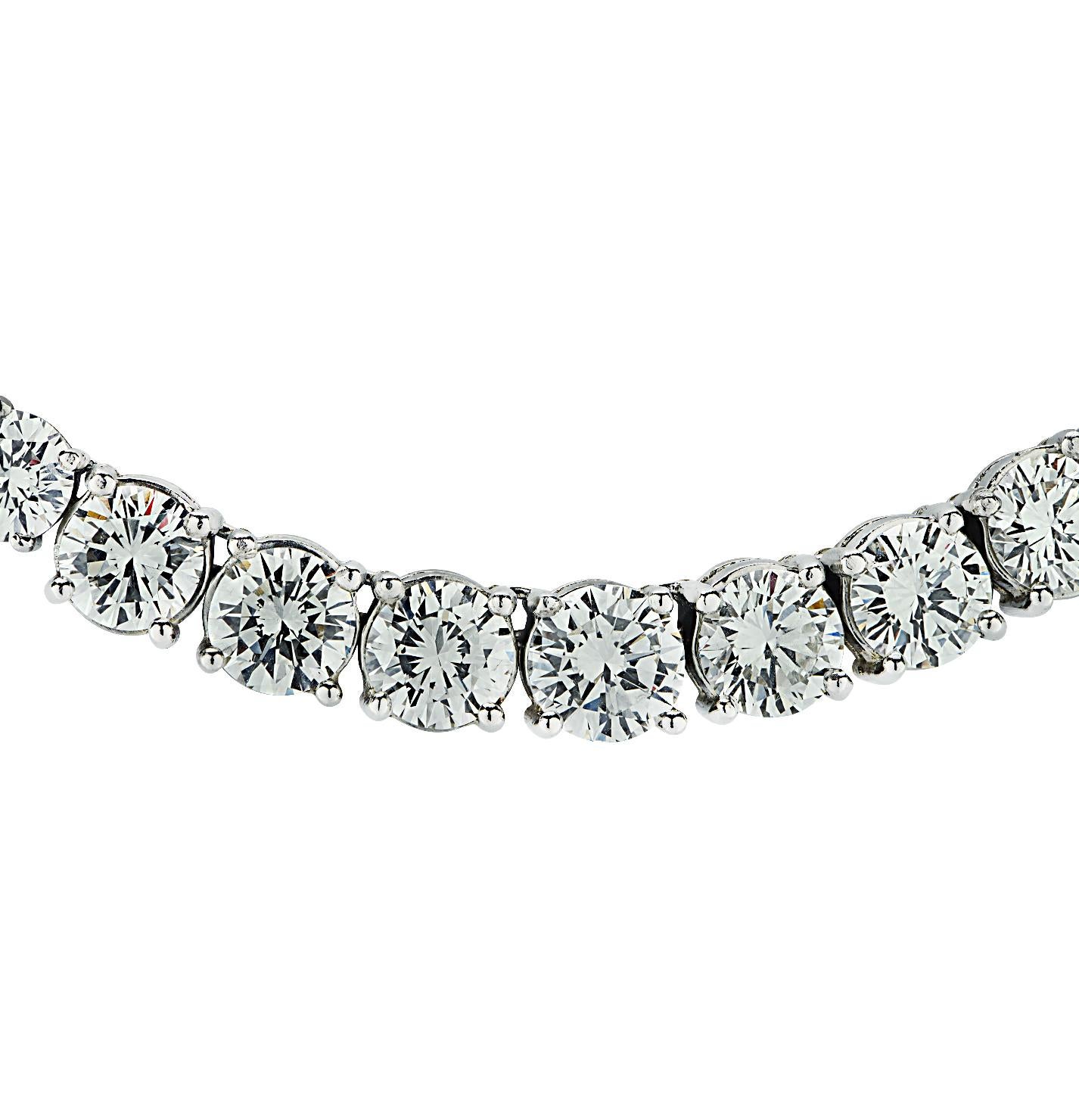 This marvelous diamond Riviera necklace, expertly crafted in platinum, showcases 73 sensational round brilliant cut diamonds weighing approximately 39.22 carats total, G-H color, VS1-VS2 clarity. The center diamond weighs approximately 1.45 carats,