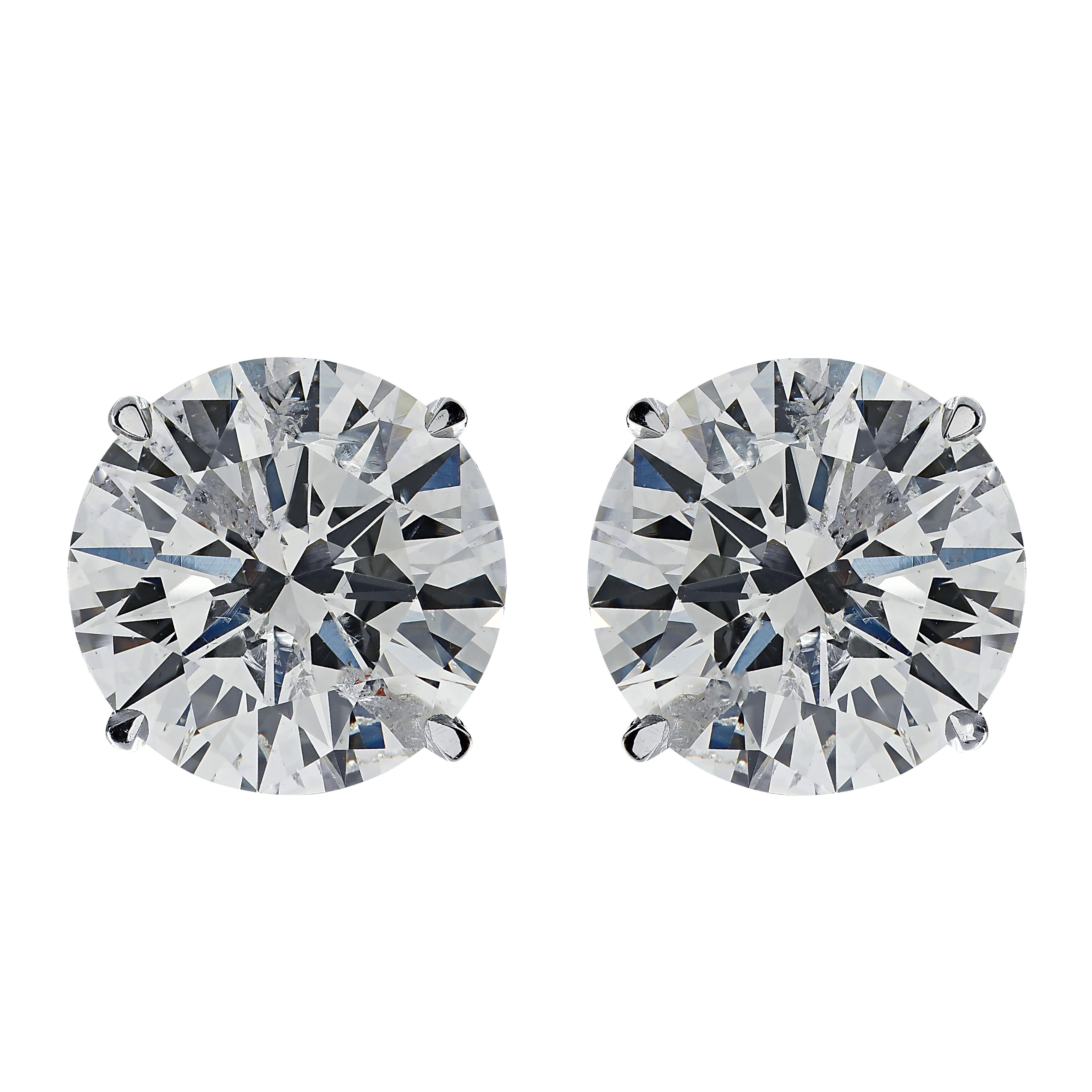 Stunning Vivid Diamonds solitaire stud earrings crafted by hand in platinum, showcasing 2 spectacular round brilliant cut diamonds weighing 4.18 carats total, I-J color, SI clarity. These diamonds were carefully selected and perfectly matched to