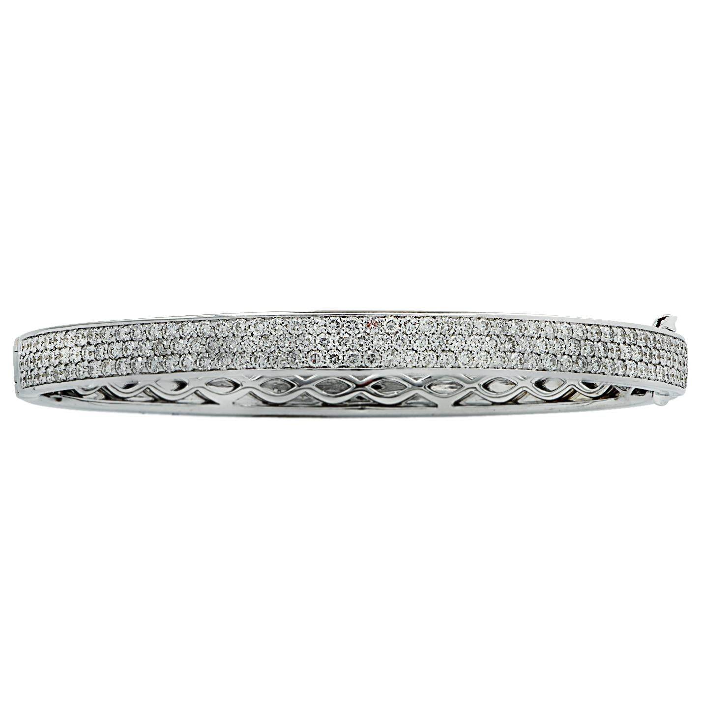 Stunning Vivid Diamonds Bangle Bracelet crafted in 18 karat white gold, featuring 296 round brilliant cut diamonds weighing 4.22 carats total, F-G color, VS-SI clarity. This spectacular bracelet is pave set with three rows of diamonds, which dazzle