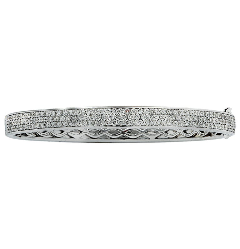 Stunning Vivid Diamonds Bangle Bracelet crafted in 18 karat white gold, featuring 302 round brilliant cut diamonds weighing 4.70 carats total, F color, VS-SI clarity. This spectacular bangle is pave set with three rows of diamonds, which dazzle with
