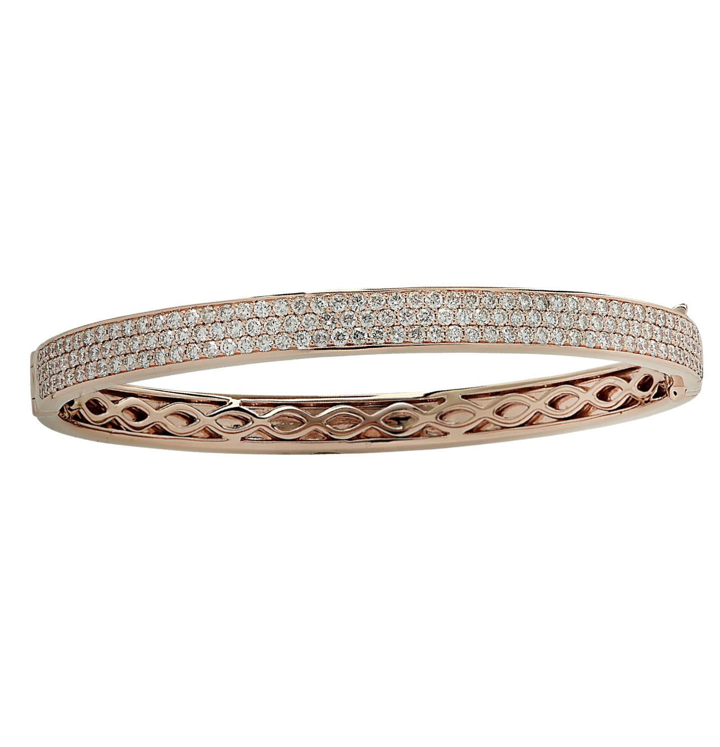 Stunning Vivid Diamonds Bangle Bracelet crafted in 18 karat Rose gold, featuring 302 round brilliant cut diamonds weighing 4.77 carats total, F color, VS-SI clarity. This spectacular bangle is pave set with three rows of diamonds, which dazzle with