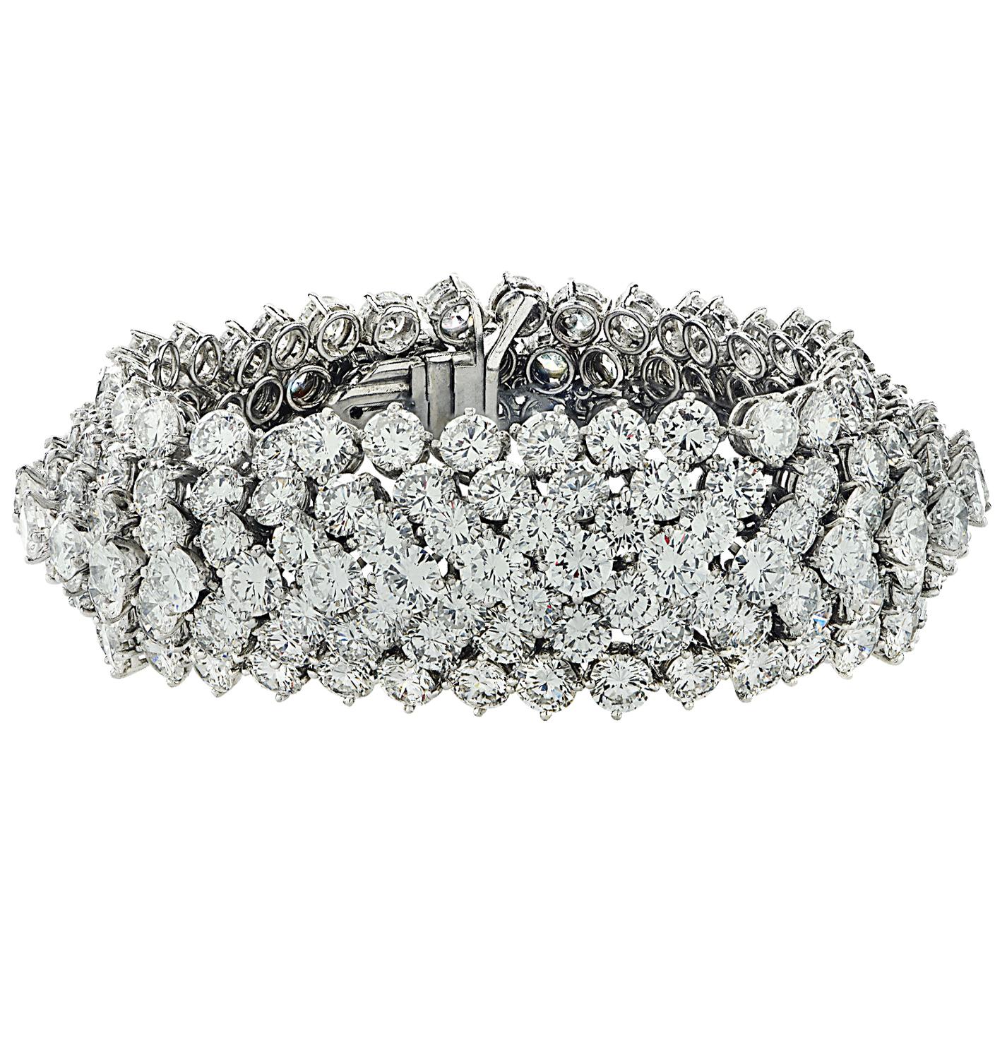 Spectacular diamond bangle bracelet crafted in platinum, featuring 245 round brilliant cut diamonds weighing approximately 78 carats total, D-F color, VVS-VS clarity. Layers of diamonds, varying in size, lace together to create this dynamic bangle