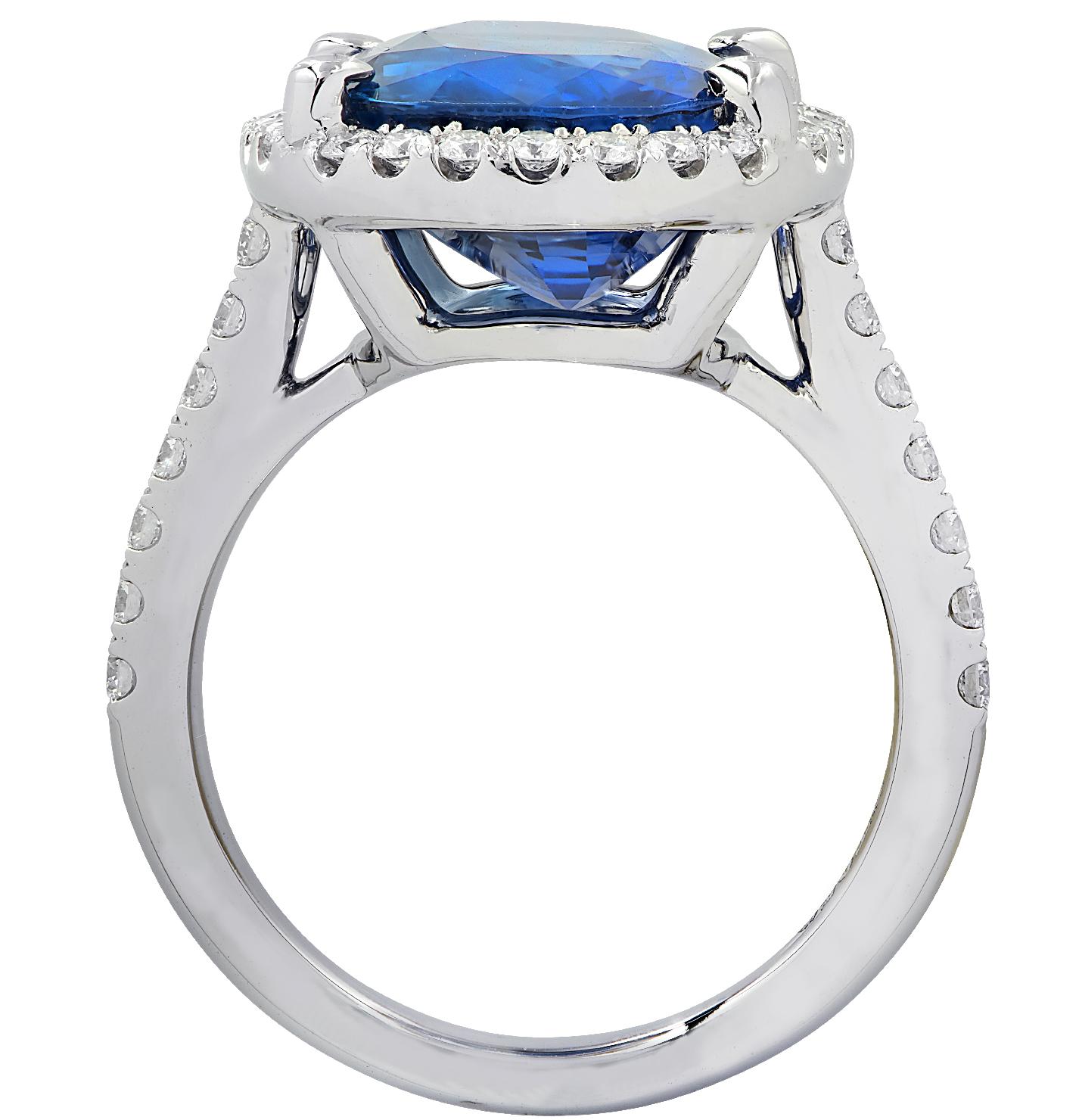 Exceptional Vivid Diamonds Sapphire and Diamond Halo Ring crafted in platinum, showcasing a spectacular blue oval sapphire weighing 9.68 carats adorned with 40 round brilliant cut diamonds weighing .64 carats total. The sapphire is surrounded by a