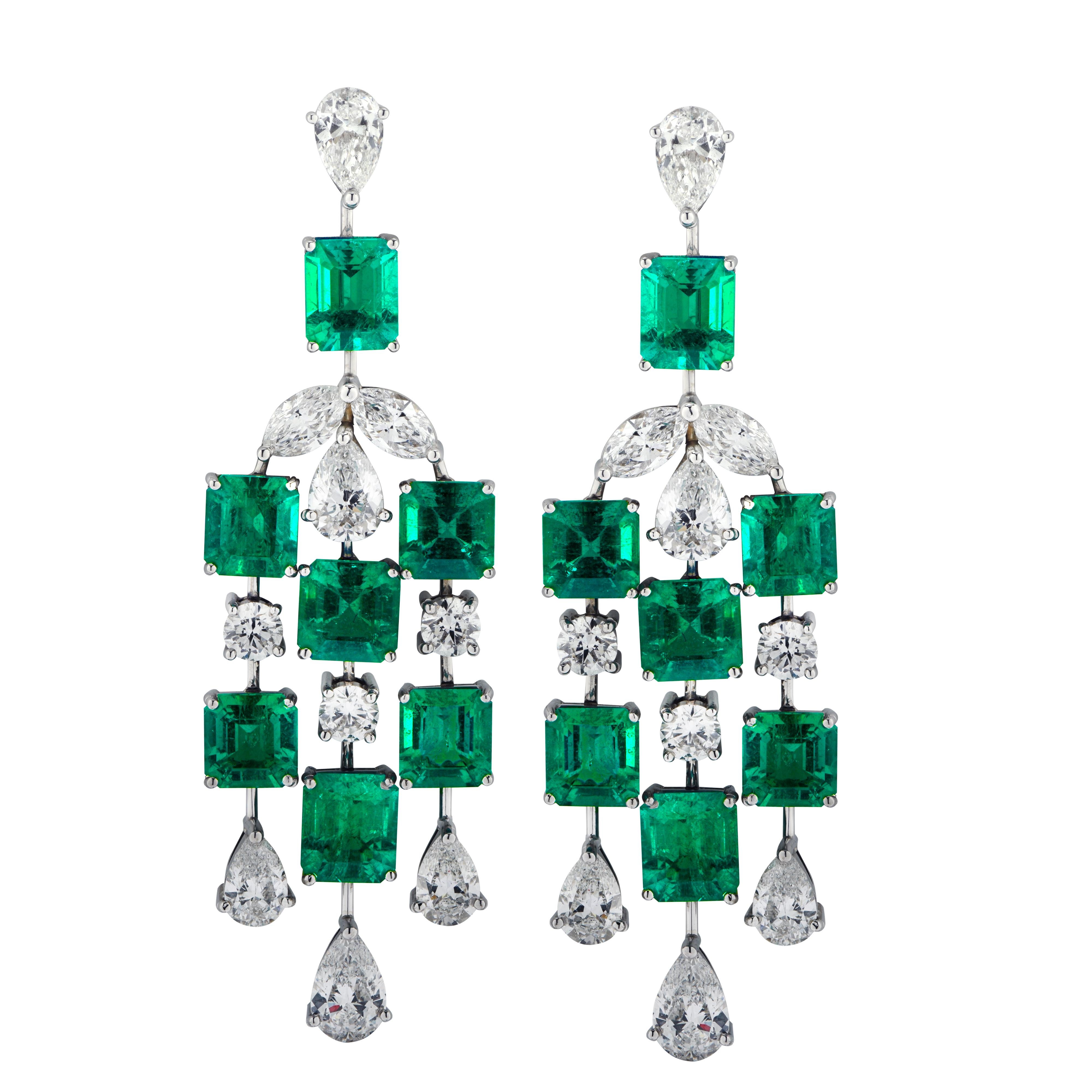 Sensational Vivid Diamonds dangle earrings crafted in platinum, showcasing 14 exquisite Emerald Cut, Vivid Green Colombian Emeralds weighing 11.11 carats total, accented by 20 Pear, Marquise and Round Brilliant cut diamonds weighing 6.15 carats