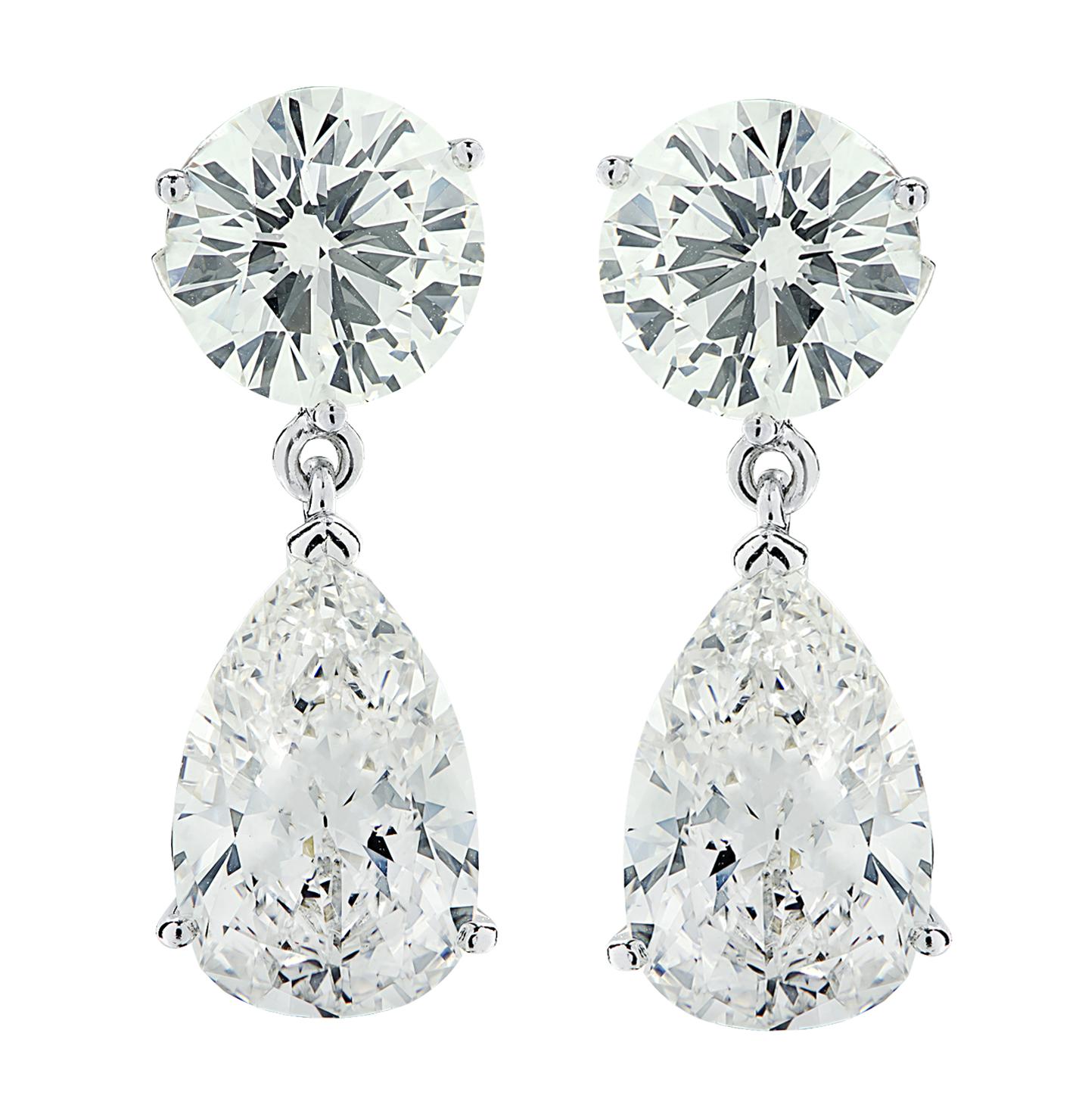 Sensational Vivid Diamonds Dangle earrings crafted in platinum showcasing 2 GIA certified round brilliant cut diamonds weighing 6.05 carats total, G-H color, VS1-SI1 clarity and 2 GIA Certified pear shape diamonds weighing 8.75 carats total, G-H