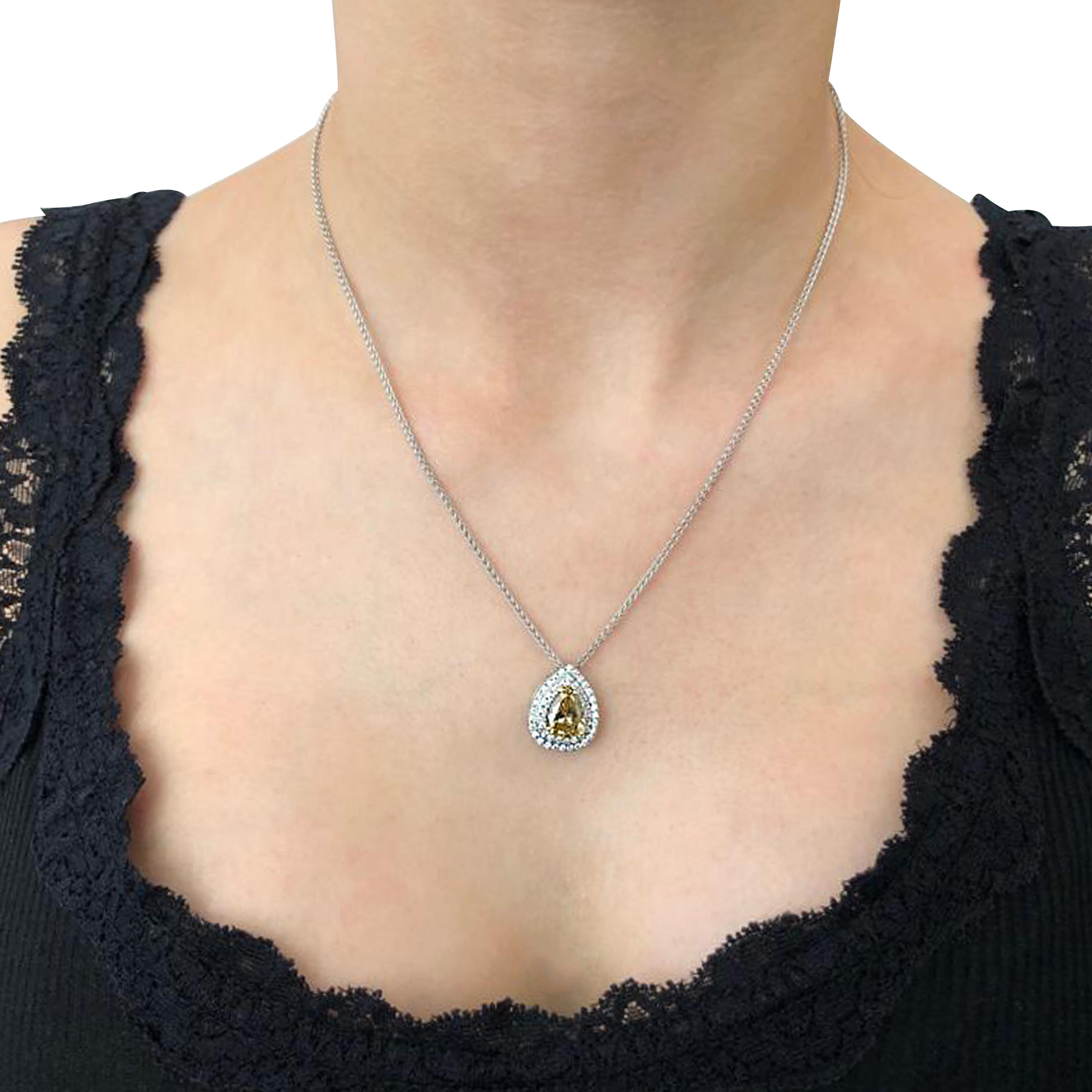 A stunning necklace crafted in 18 karat white gold featuring a gorgeous GIA certified natural fancy deep brownish yellow 2.01ct pear shape diamond gracefully surrounded by 49 round brilliant cut diamonds weighing .35cts total, F - G color VS