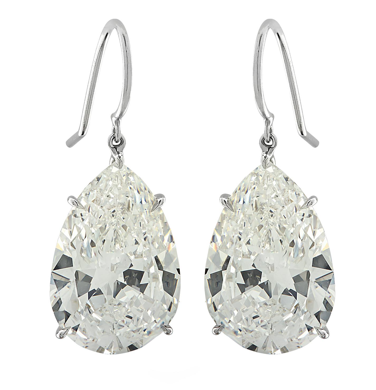 Exquisite Vivid Diamonds Dangle Earrings crafted in Platinum showcasing two sensational GIA graded pear shape diamonds weighing 20.48 carats total, I-J color, VS2-SI1 clarity. The diamonds were carefully selected, perfectly matched and set to dance