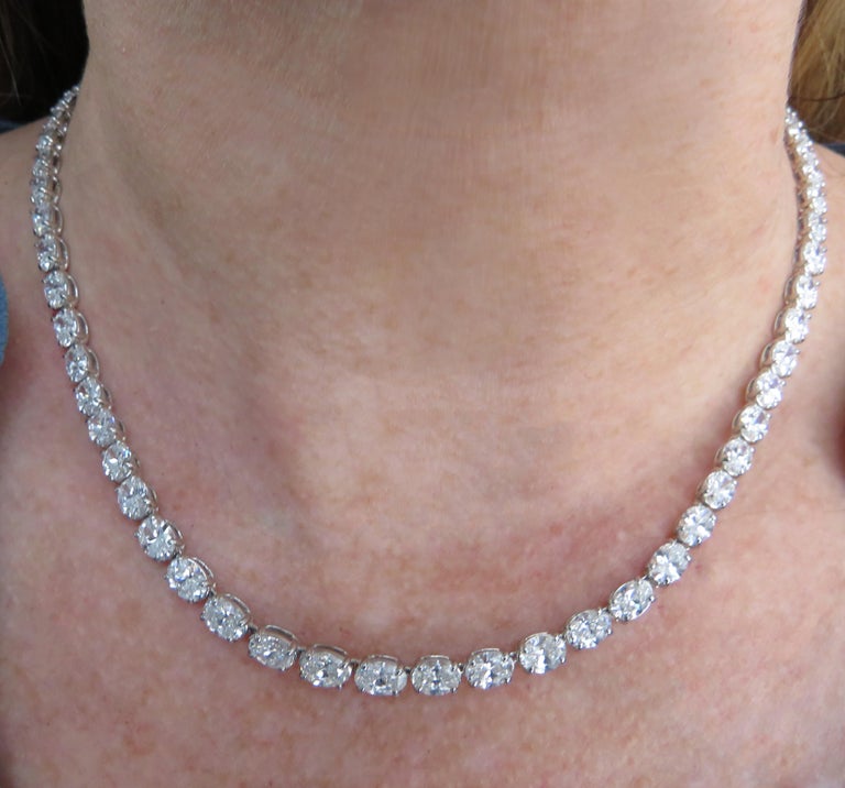 Exquisite Vivid Diamonds diamond tennis necklace crafted in platinum, featuring 75 GIA Certified oval cut diamonds weighing 22.76 carats total, D-G color, VS2-SI1 clarity. Each stone was carefully selected, perfectly matched and set, East to West,