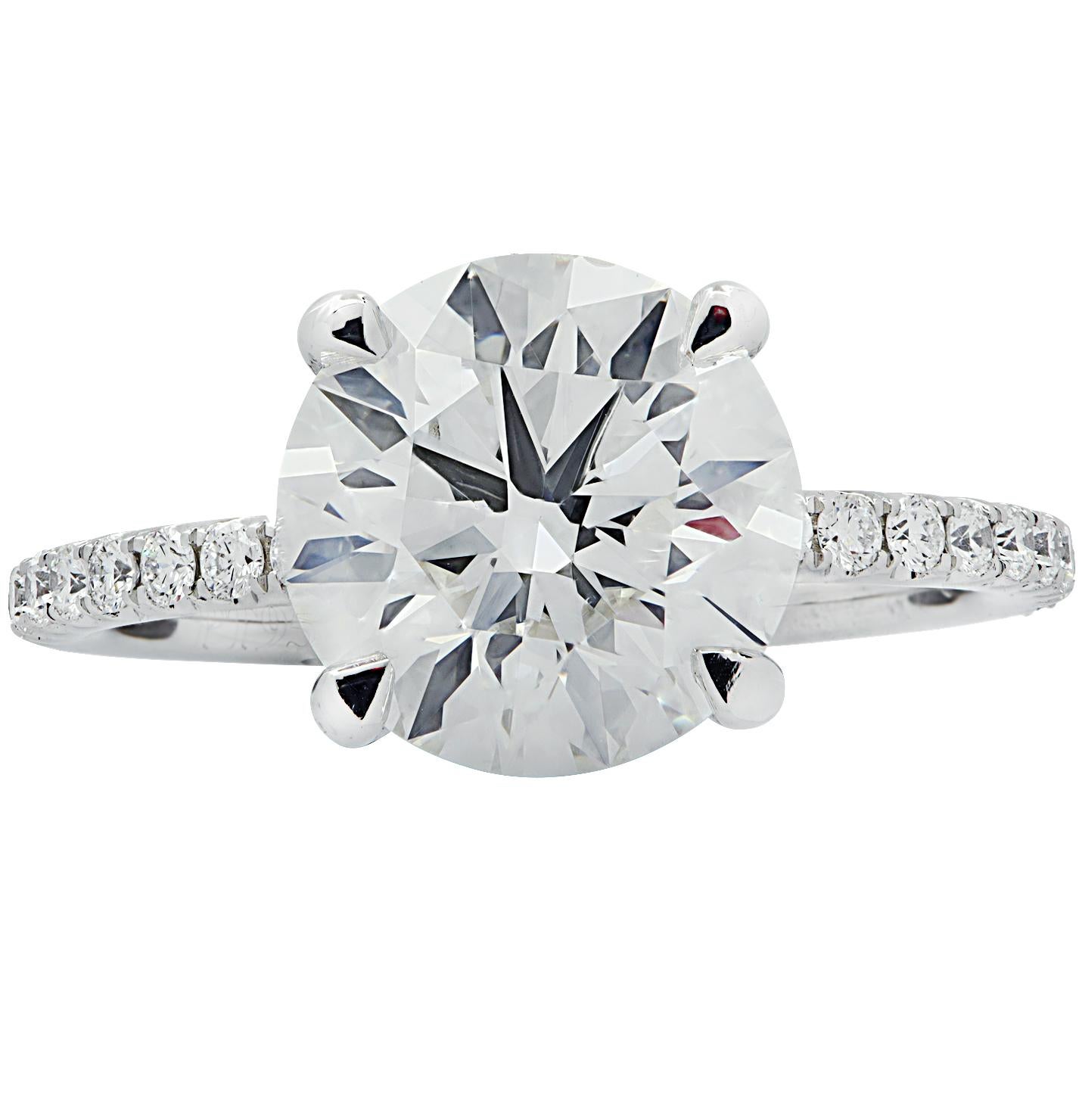 Exquisite engagement ring crafted in platinum showcasing a stunning GIA certified round brilliant cut diamond weighing 3.56 carats, I color, SI1 clarity. The band is encrusted with 22 round brilliant cut diamonds weighing .29 carats total, G color,