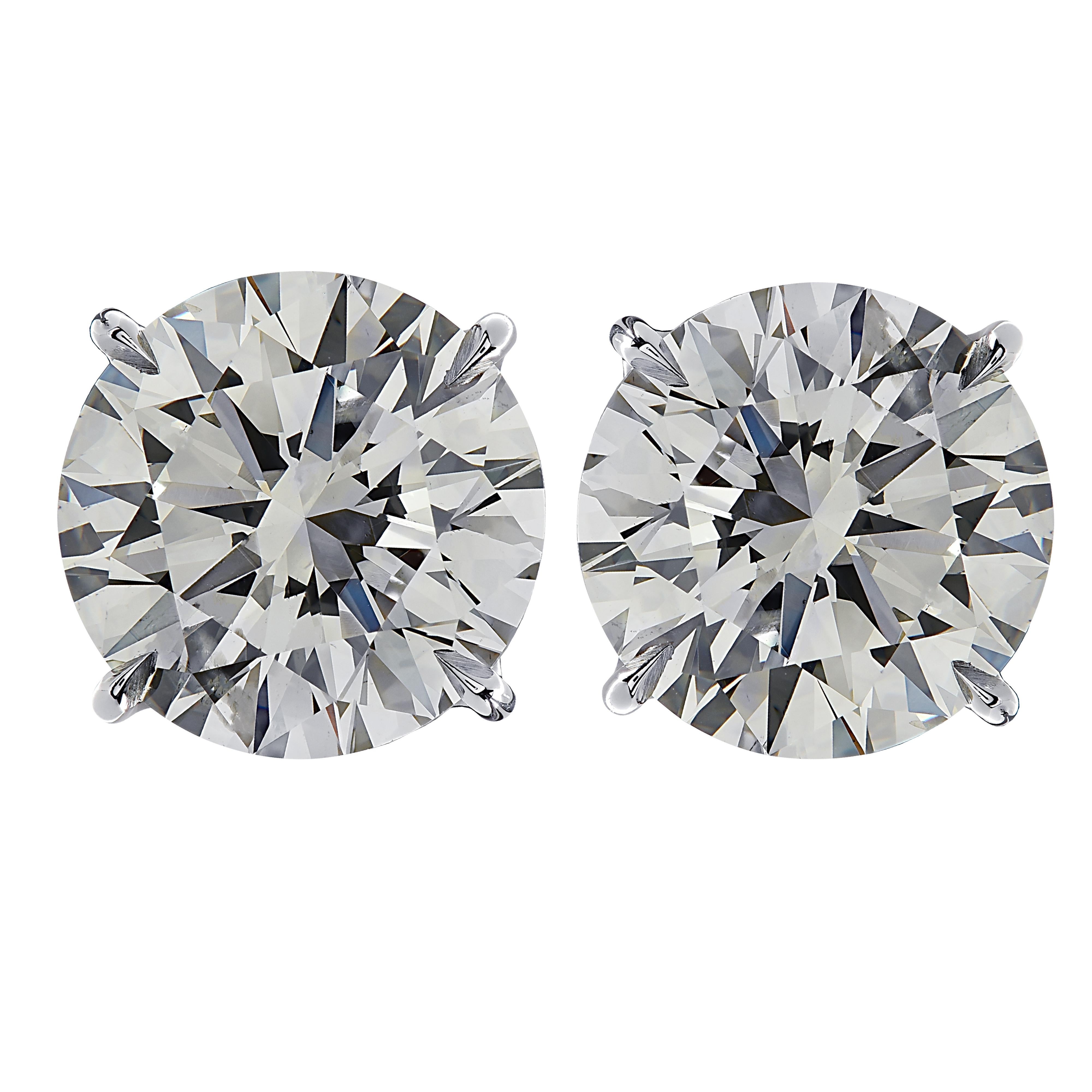 Stunning Vivid Diamonds solitaire stud earrings crafted by hand in platinum, showcasing 2 spectacular GIA Certified round brilliant cut diamonds weighing 4.01 carats total, H color SI1 clarity. These diamonds were carefully selected and perfectly