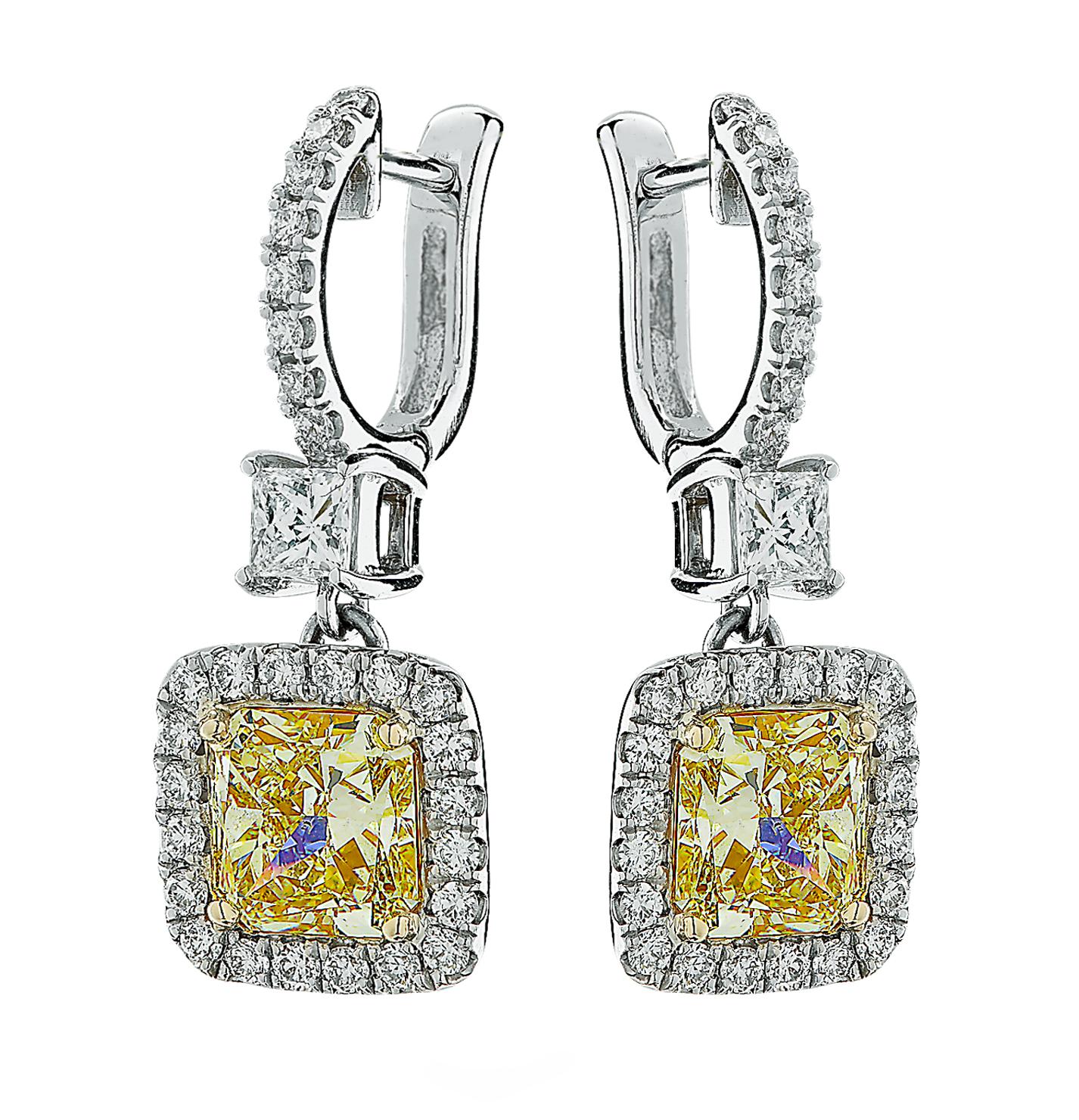 Exquisite Vivid Diamonds dangle earrings crafted in 18 karat yellow and white gold, showcasing two perfectly matched GIA certified Radiant Cut diamonds, one weighing 3.20 carats, W-Z color, VS2 clarity and one weighing 3.01 carats, W-Z color, SI1