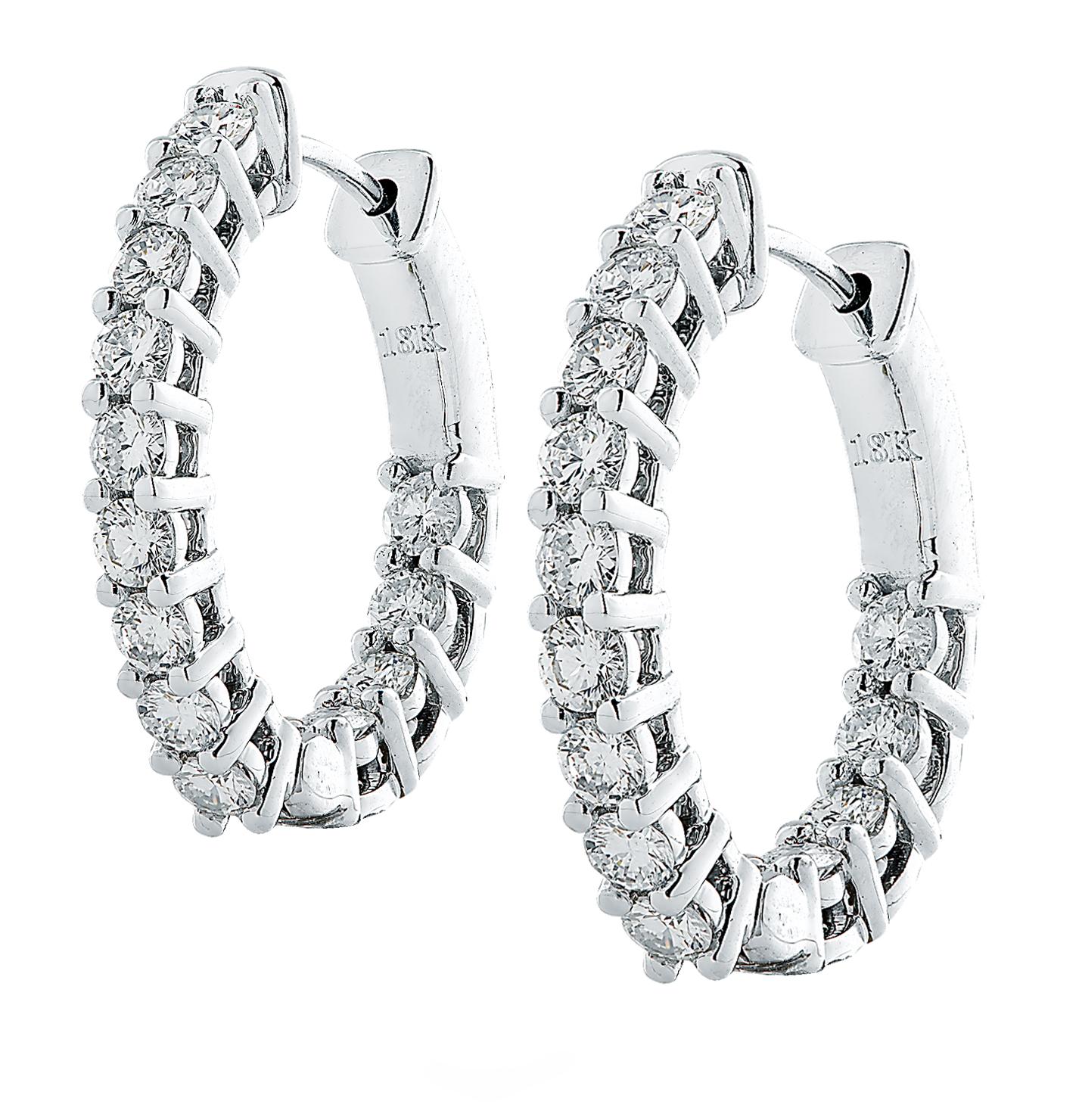 Spectacular Vivid Diamonds In/Out diamond hoop earrings crafted in 18 karat white gold showcasing 26 round brilliant cut diamonds weighing 1.57 carats total, G-H color, VS-SI clarity. Each diamond is carefully selected, perfectly matched and set on