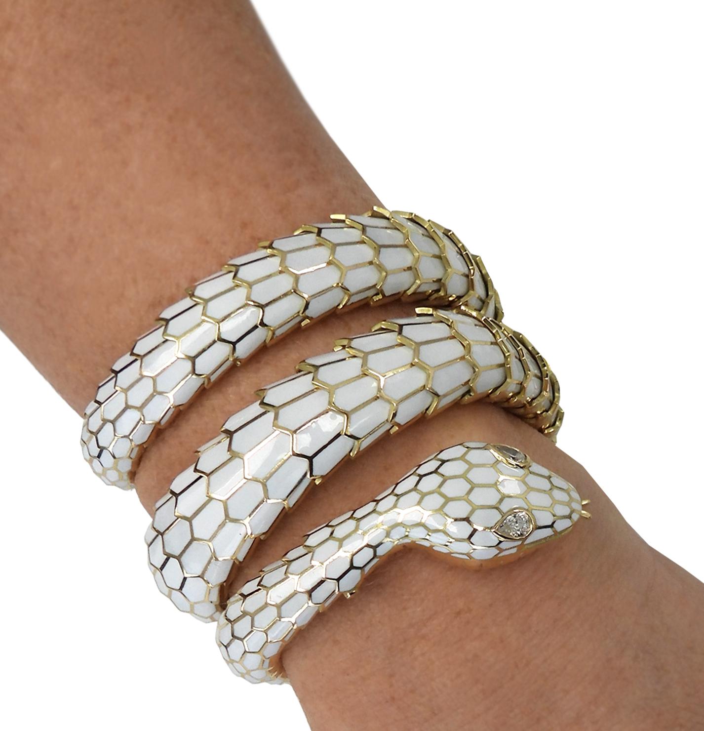 Emanating from the illustrious ateliers of Vivid Diamonds, behold a captivating masterpiece: a serpent, sculpted with finesse in 18 karat gold and crafted in Italy. This sensuous creature is caressed by a layer of pristine white enamel, and its