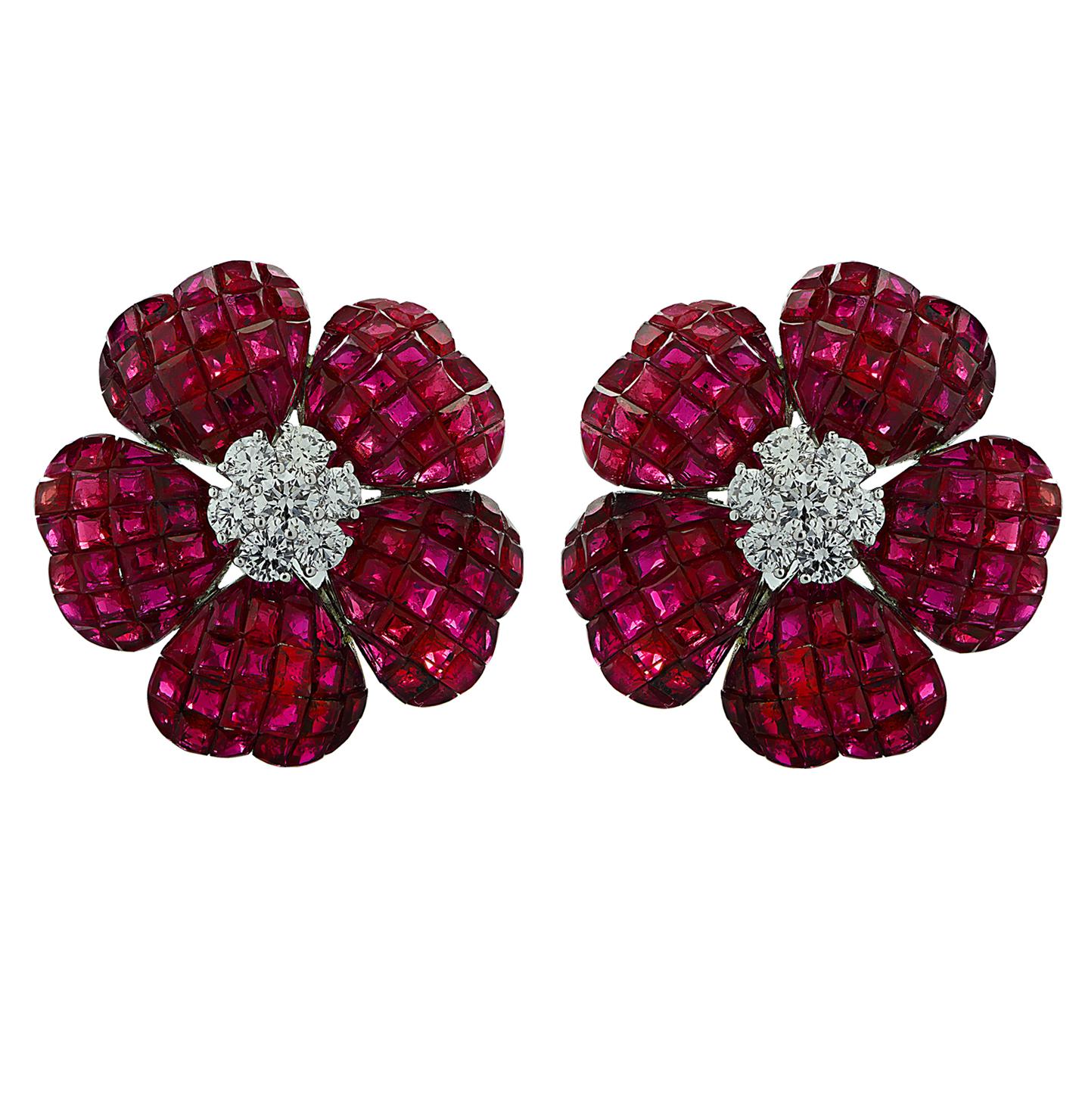 Enchanting Ruby and Diamond Stud Earrings crafted in 18 karat white gold, featuring square cut Rubies weighing approximately 37.85 carats total, and round brilliant cut diamonds weigh approximately 1.10 carats total, G color, VS clarity. Heart shape
