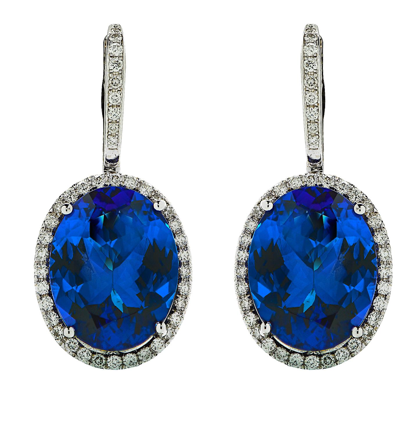 Dazzling Tanzanite and Diamond dangle earrings crafted in 18 karat white gold, showcasing 2 beautiful tanzanite gemstones weighing approximately 22.16 carats total, surrounded by 84 round brilliant cut diamonds weighing approximately .95 carats
