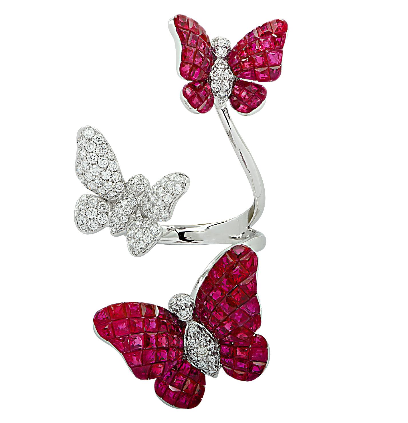 Enchanting ring crafted in 18 karat white gold featuring square cut rubies weighing approximately 12.85 carats total and round brilliant cut diamonds weighing approximately .87 carats total. Two butterflies adorned with invisibly set deep blue