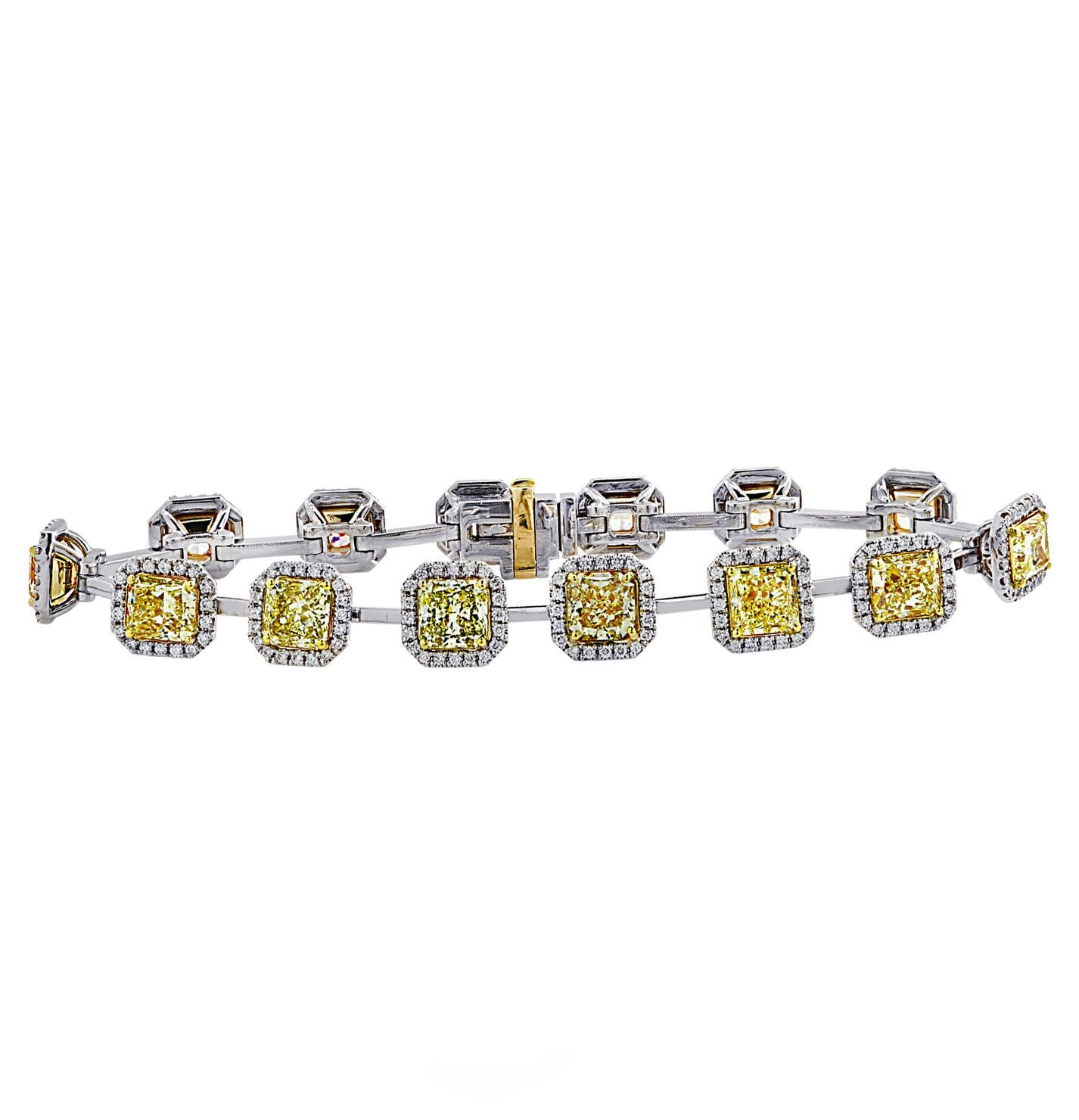 Spectacular Vivid Diamonds bracelet crafted in platinum and 18 karat yellow gold, featuring 14 GIA Certified radiant cut diamonds weighing 12.82 carats total, ranging in color from Fancy Yellow to U color, VVS-SI clarity, framed in 258 round