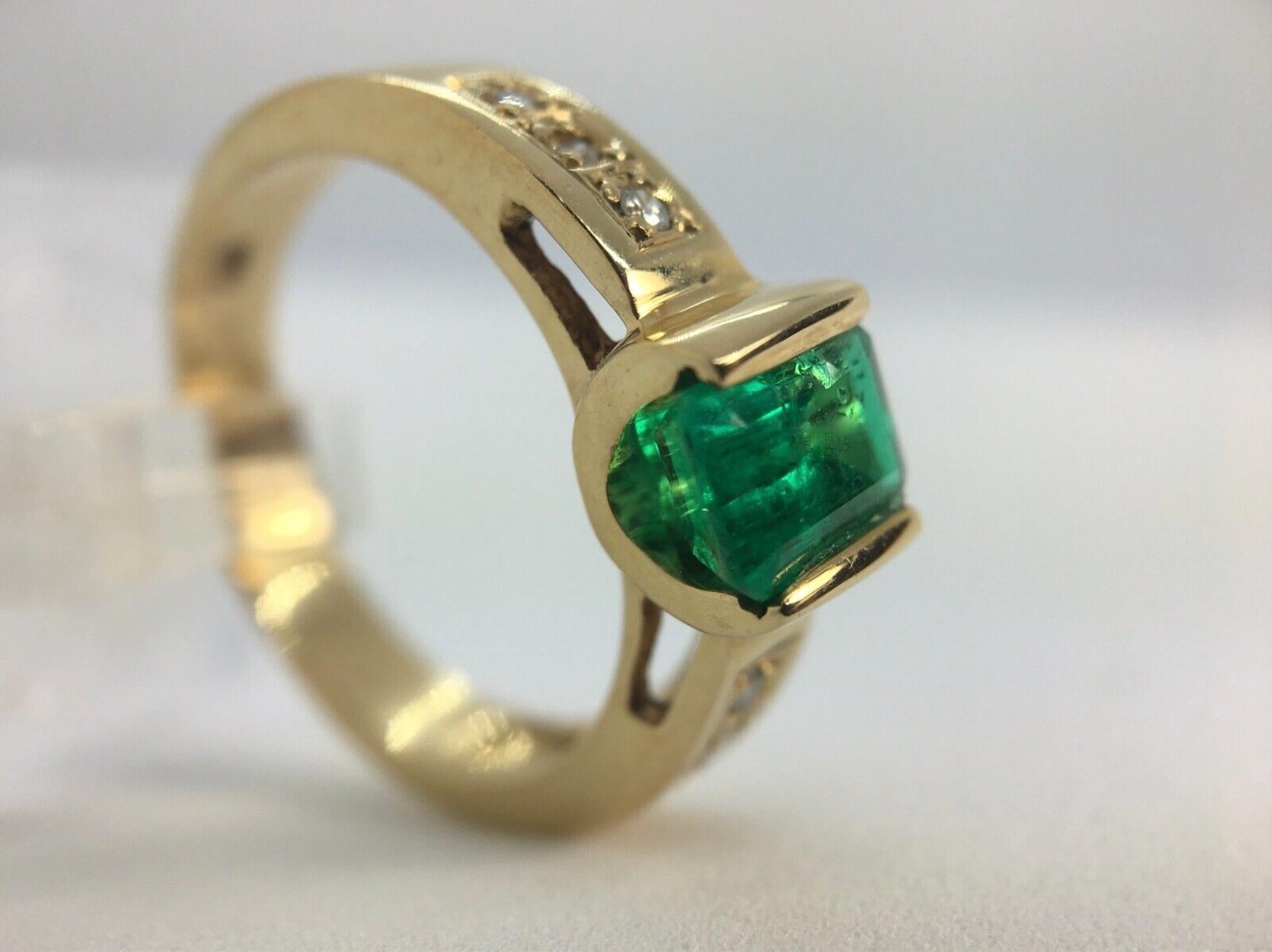 Vivid Colombian Emerald Solitaire Ring ,The Center Stone in a two sides Bezel Mounting. 
Feature one Genuine and natural Colombian Emerald (Emerald cut) Approximately 1.30ct Vivid Intense Medium Green. The ring has is accent with 6 brilliant cut