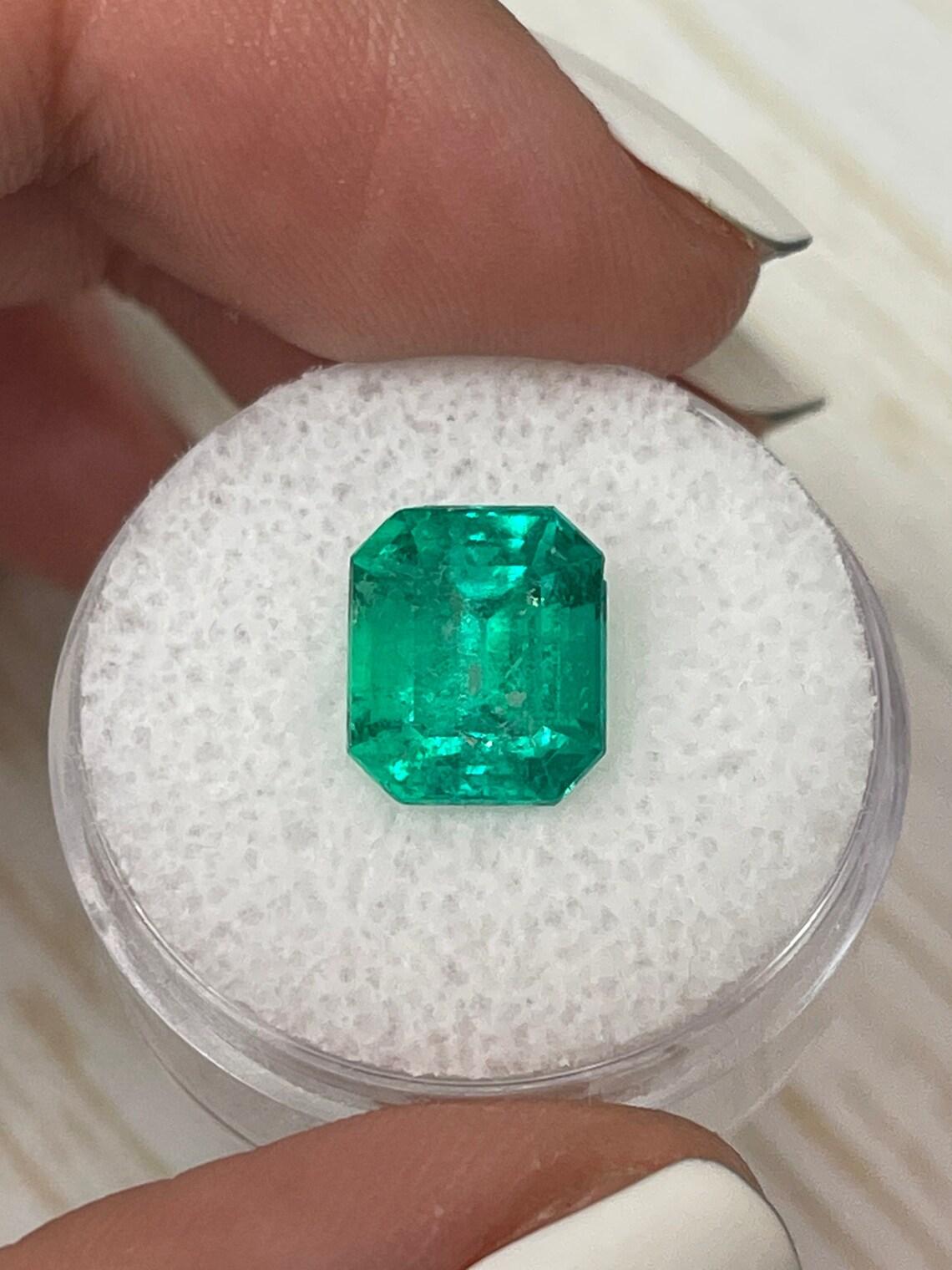 Stone: Emerald
Weight: 4.26-carats
Shape: Emerald Cut
Clarity: Transparent
Luster: Very Good
Color: Vivid Green
Measurements: 10.14mm x 8.75mm x 7.35mm
Geographic Origin: Colombia
Treatment: Natural, Oiling

This emerald has a small natural chip on