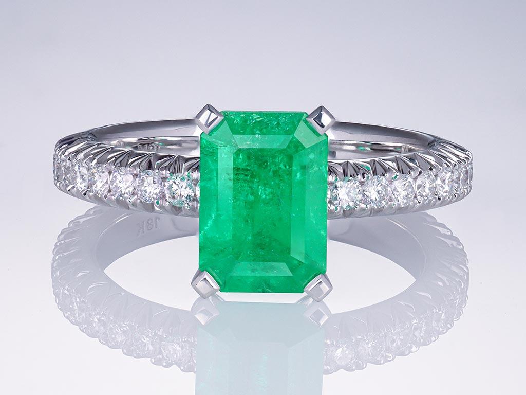 The 1.71 carat Vivid Green Colombian Emerald has a stylish emerald-cut shape, and its rich hue gives the stone a special, unique look. 

Surrounding the mesmerizing emerald are 36 brilliant-cut diamonds, each a testament to the highest standards of