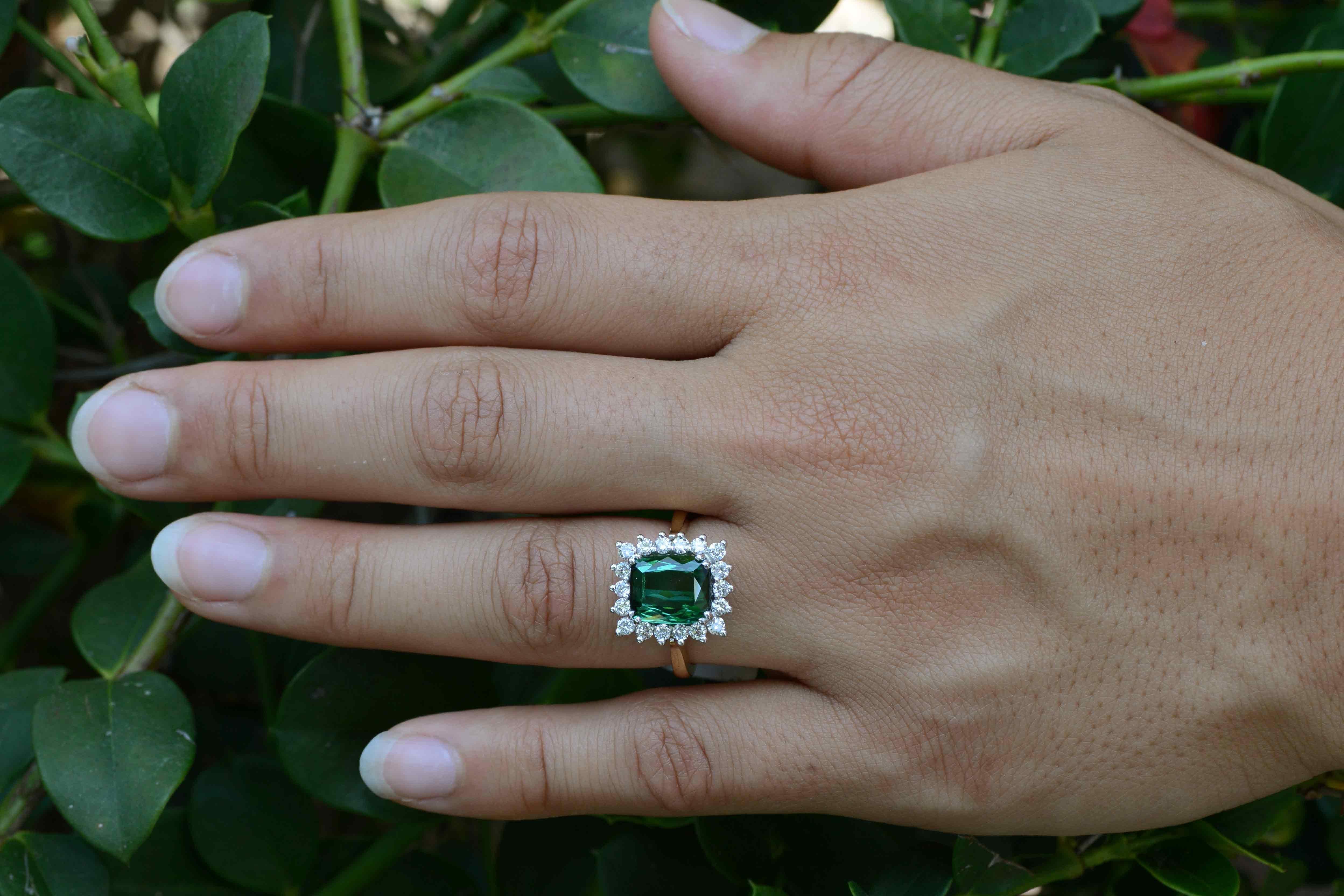 This amazingly beautiful, lively and lustrous green Tourmaline of 3.40 carats makes for a wonderful gemstone engagement ring. Set atop a white gold basket that allows the light to penetrate it from all angles and rendered in a timeless Princess