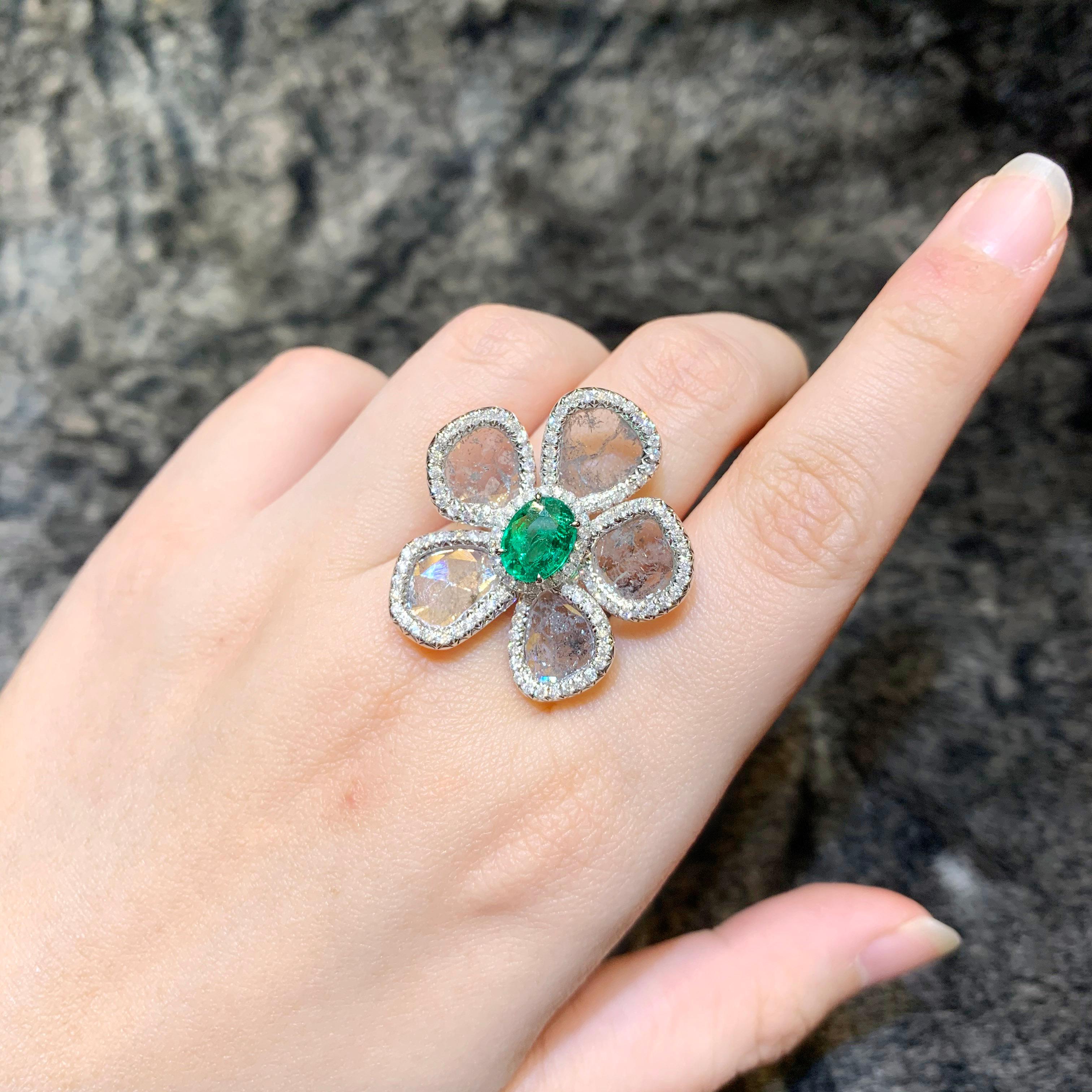 1.42 carat of Vivid Green Zambian Emerald is surrounded by 3.7 carat of Salt and Pepper Slice Diamond and 0.85 carat of white brilliant round diamond. 