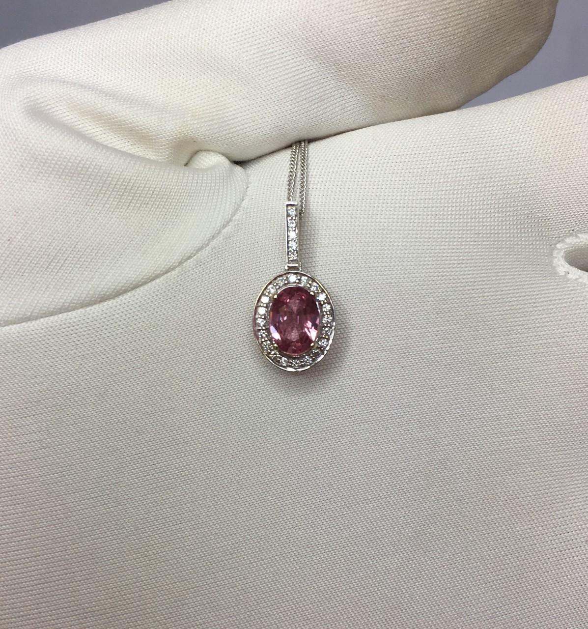 Stunning natural Pink Ceylon sapphire set in a fine 18k white gold diamond cluster pendant. 

0.80 carat centre sapphire with stunning bright pink colour and excellent clarity.
Ceylon in origin it also has an excellent oval cut to show lots of