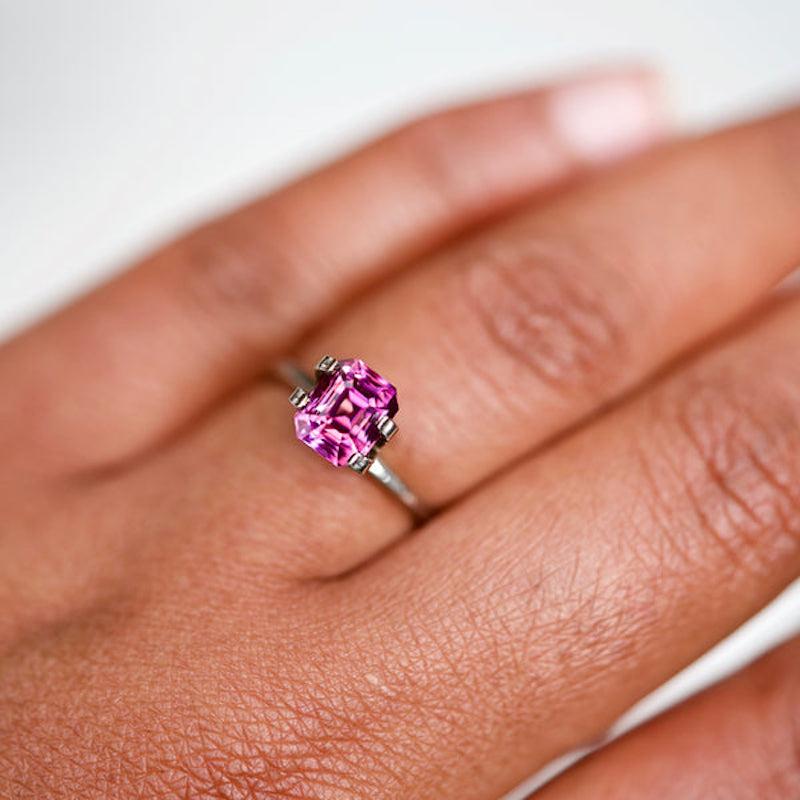 Traditionally hand-cut this emerald shaped gemstone from Madagascar gives rise to a lively and vivacious vivid pink sapphire of over 2 carat. Hues of pink citrus crush are increased by the use of heat treatment and dispersed in geometric radiance. A