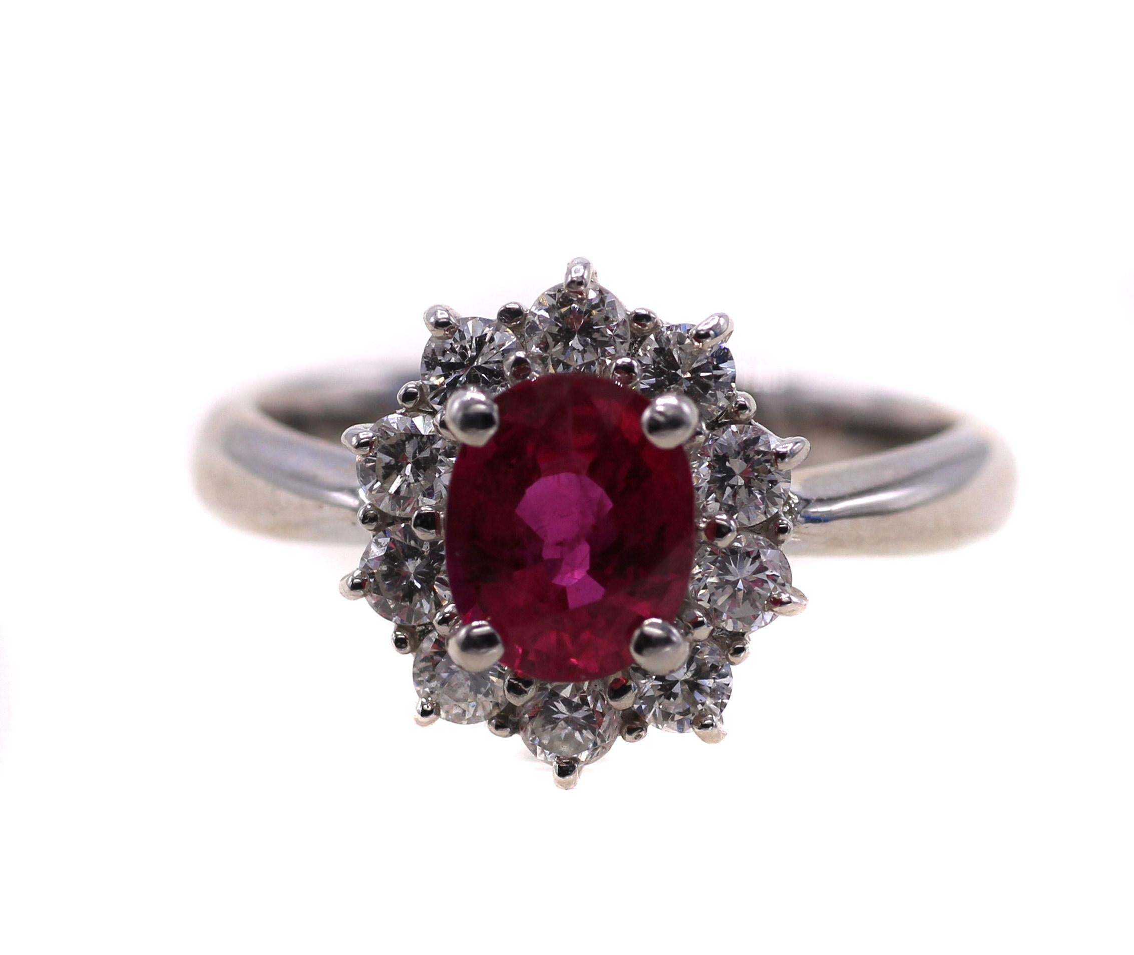 A lively oval vivid red Ruby, weighing 1.21 carats is the centerpiece of this masterfully handcrafted platinum engagement ring. The perfectly cut oval ruby exhibits an amazing saturation of color and brilliance. With very few natural inclusions it