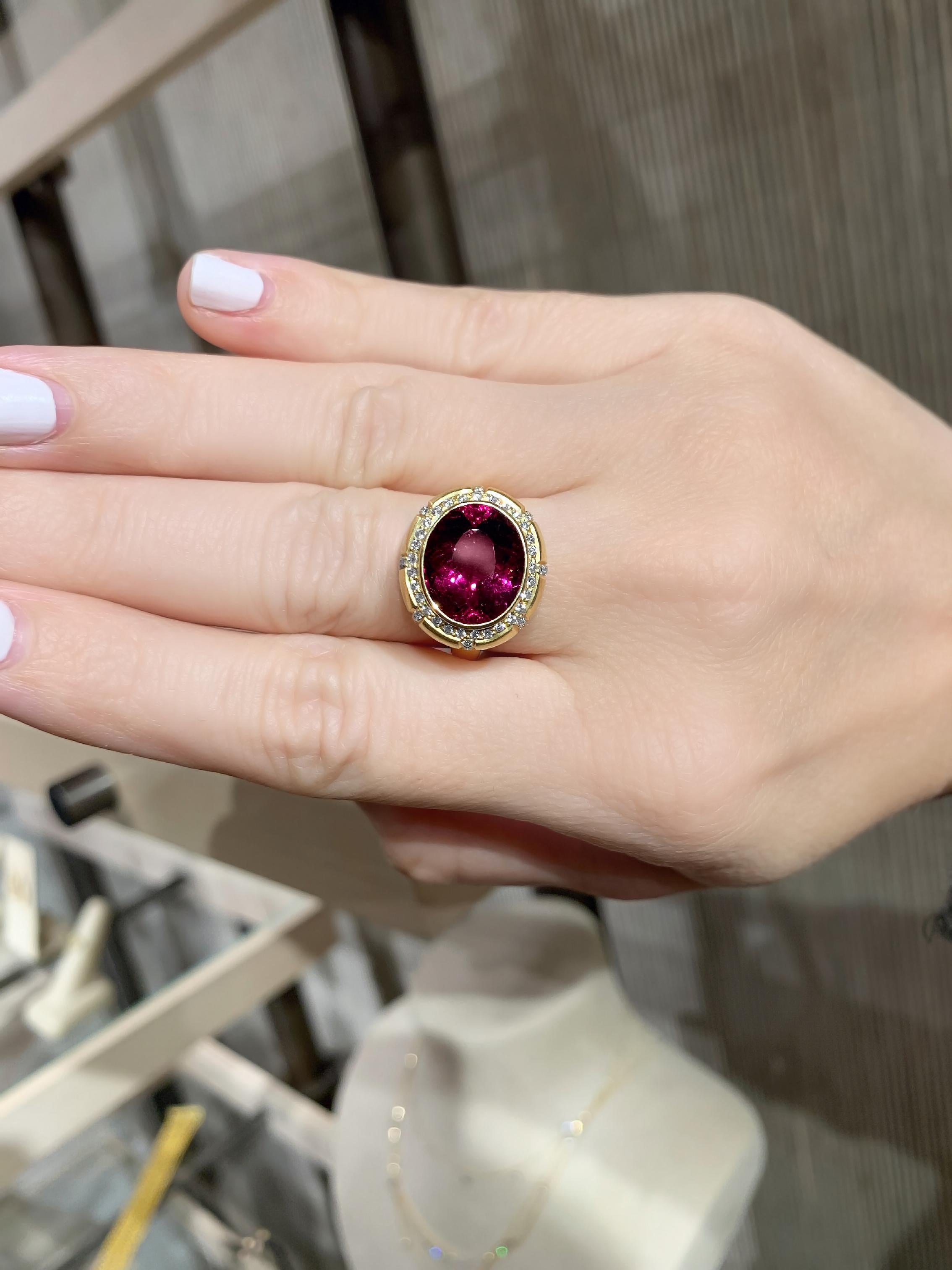 One of a Kind Queen's Crown Ring intricately hand-fabricated in satin-finished 18k yellow gold by jewelry artist Tej Kothari featuring a shimmering, vivid rubelite tourmaline faceted oval surrounded and accented by 0.46 total carats of round