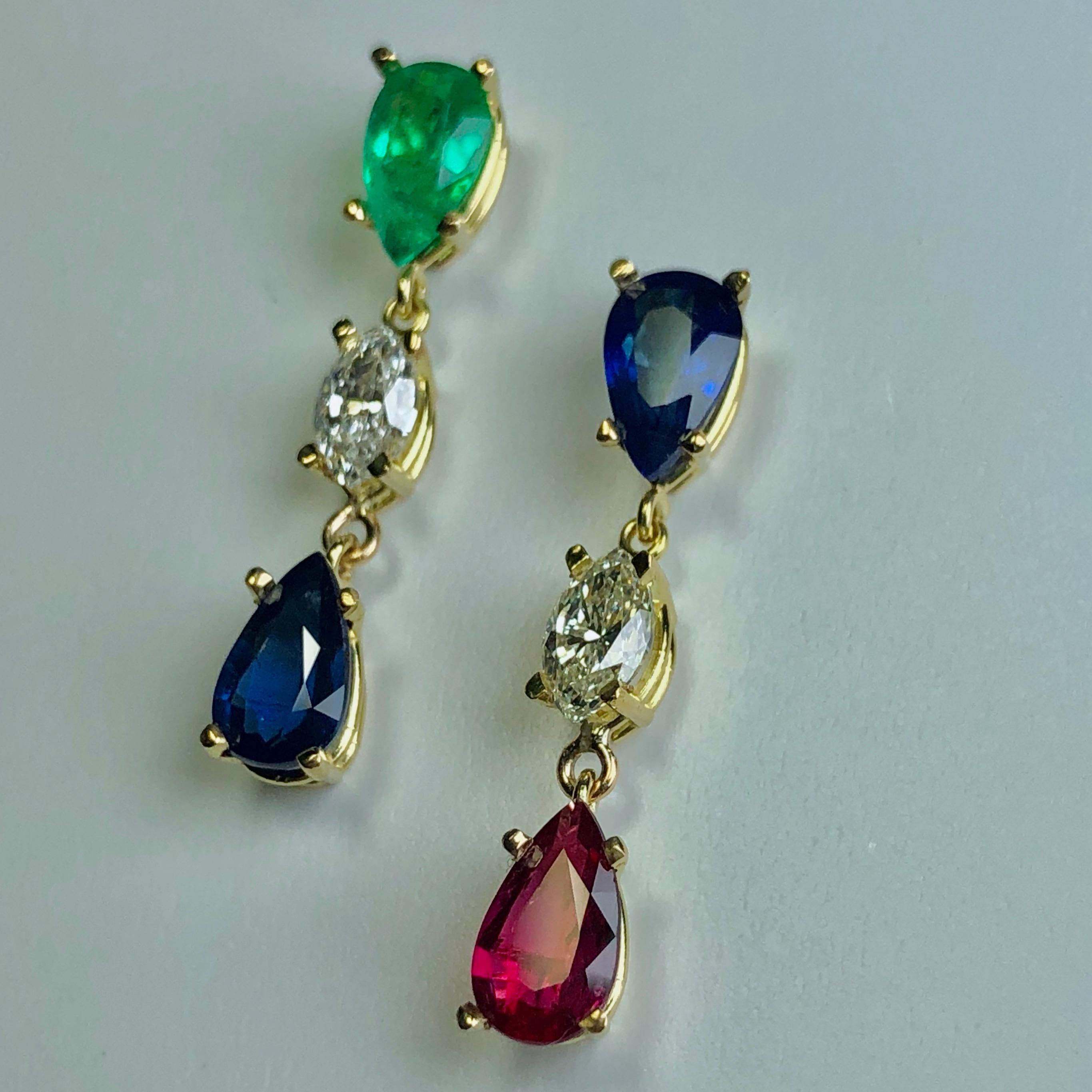 Extraordinary drop dangle earrings designed with blue Burma sapphire, Intense green Colombian emerald, vivid red ruby, and sparkling diamonds. All the natural color gemstones are pear-cut, they have excellent clarity and transparency, bold color.