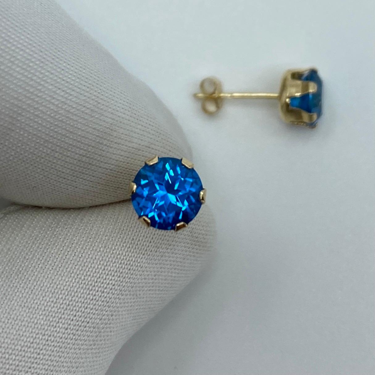 Natural Swiss Blue 2 Carat Topaz Yellow Gold Earring Studs.

Beautiful 6mm matching pair of round topaz with vivid Swiss blue colour, excellent clarity and an excellent round brilliant cut.

Set in lightweight 9k yellow gold suds with butterfly