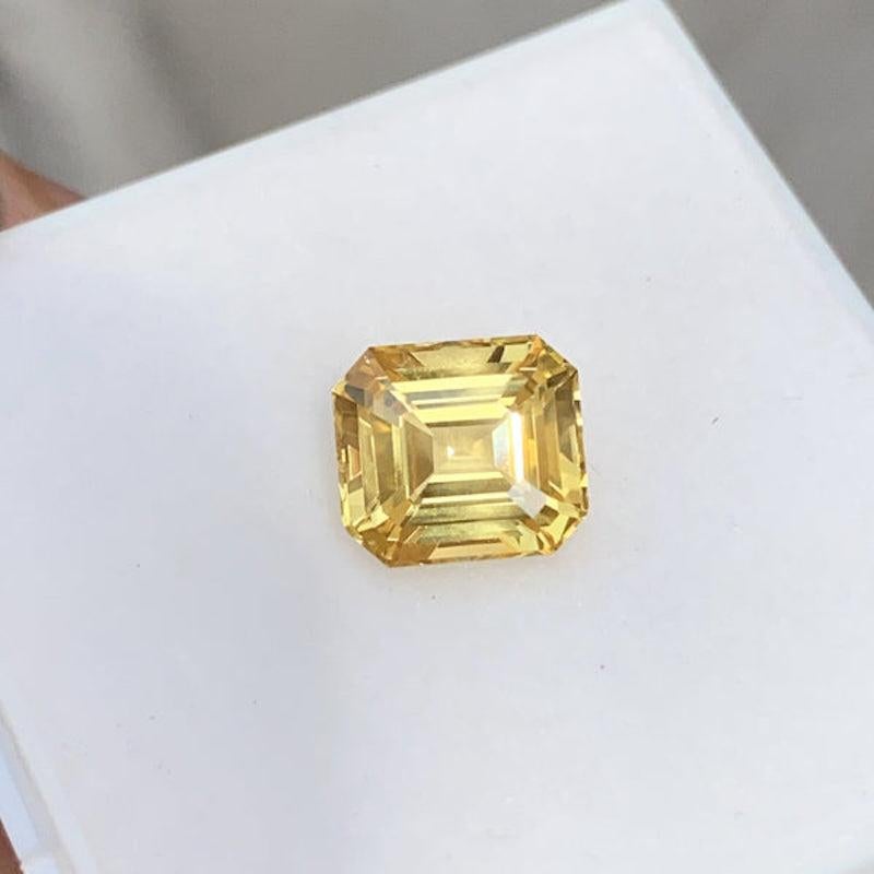 Bursting with colour and vitality a large yellow sapphire that will fill your heart with sunshine and joy. Like a dramatic sunrise with shards of light radiating from each corner of this emerald cut yellow sapphire, shaped by our cutters using