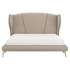 VIVIEN bed covered in fabric with contrasting piping