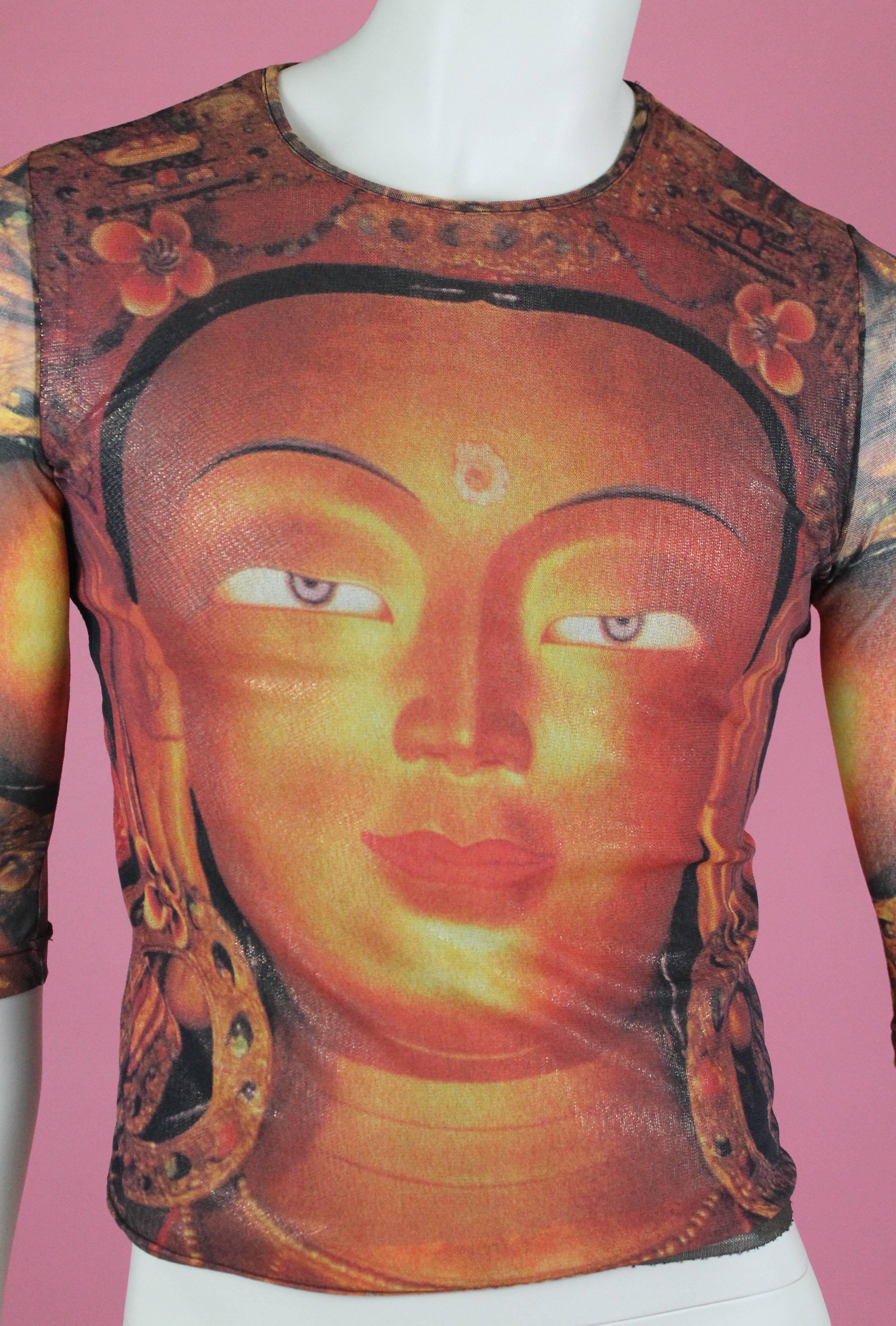 -Totally cool top from Chinese-American designer Vivienne Tam
-Features Buddha on the front as well as the back of shirt
-Top is sheer but has a shimmering lining underneath (sleeves are unlined)
-Unisex item, would be ideal as a muscle tee on