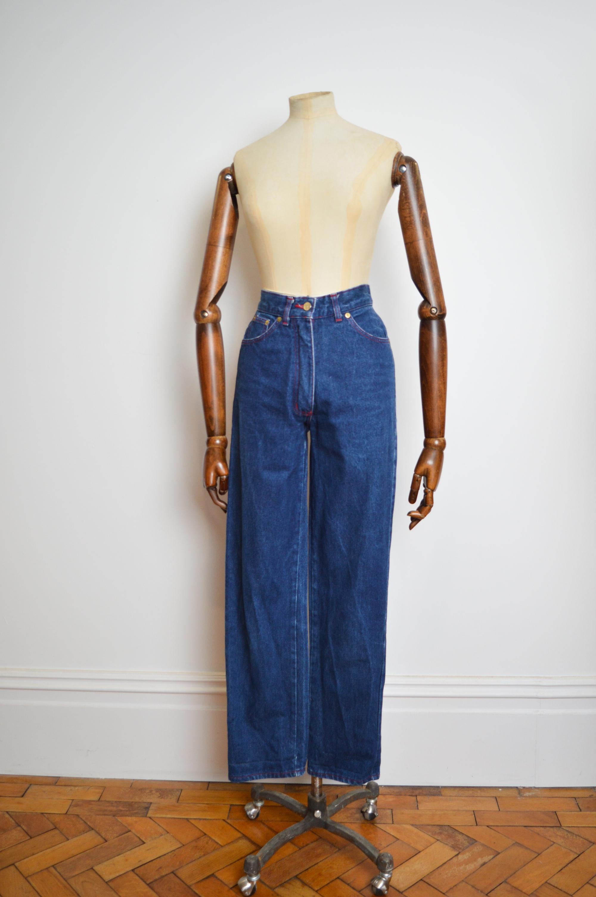 Early 1990's Vivienne Westwood Dark Blue High waisted denim jeans with the Iconic red Westwood Tab on the Back.
MADE IN ENGLAND 
‘W’ stitch detail on pockets
Orb embossed button
Classic 4 pocket design 
Size; 26” inch Waist 
Waist; 26”
Leg;