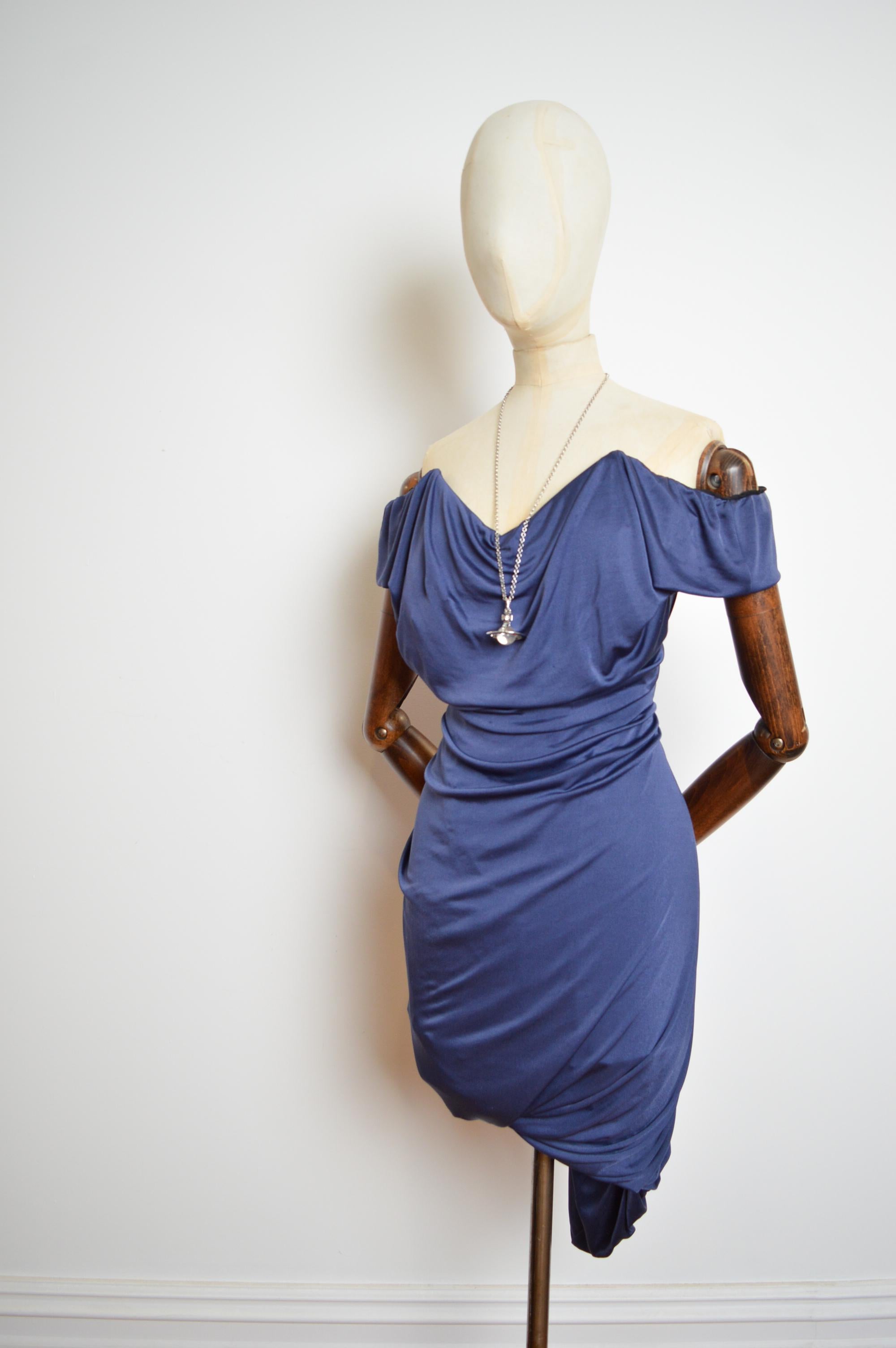 A Superb, 2012 Lotus blue, draped corset dress by Vivienne Westwood !

Measurements are provided in Inches;
Pit to Pit; 16” - 17”
Waist; 26” - 29”
Top of Shoulder to Hem; Approx 34”
Size; Small / Stretchy / U.K. 8 - 10
Condition; 7/10 some very