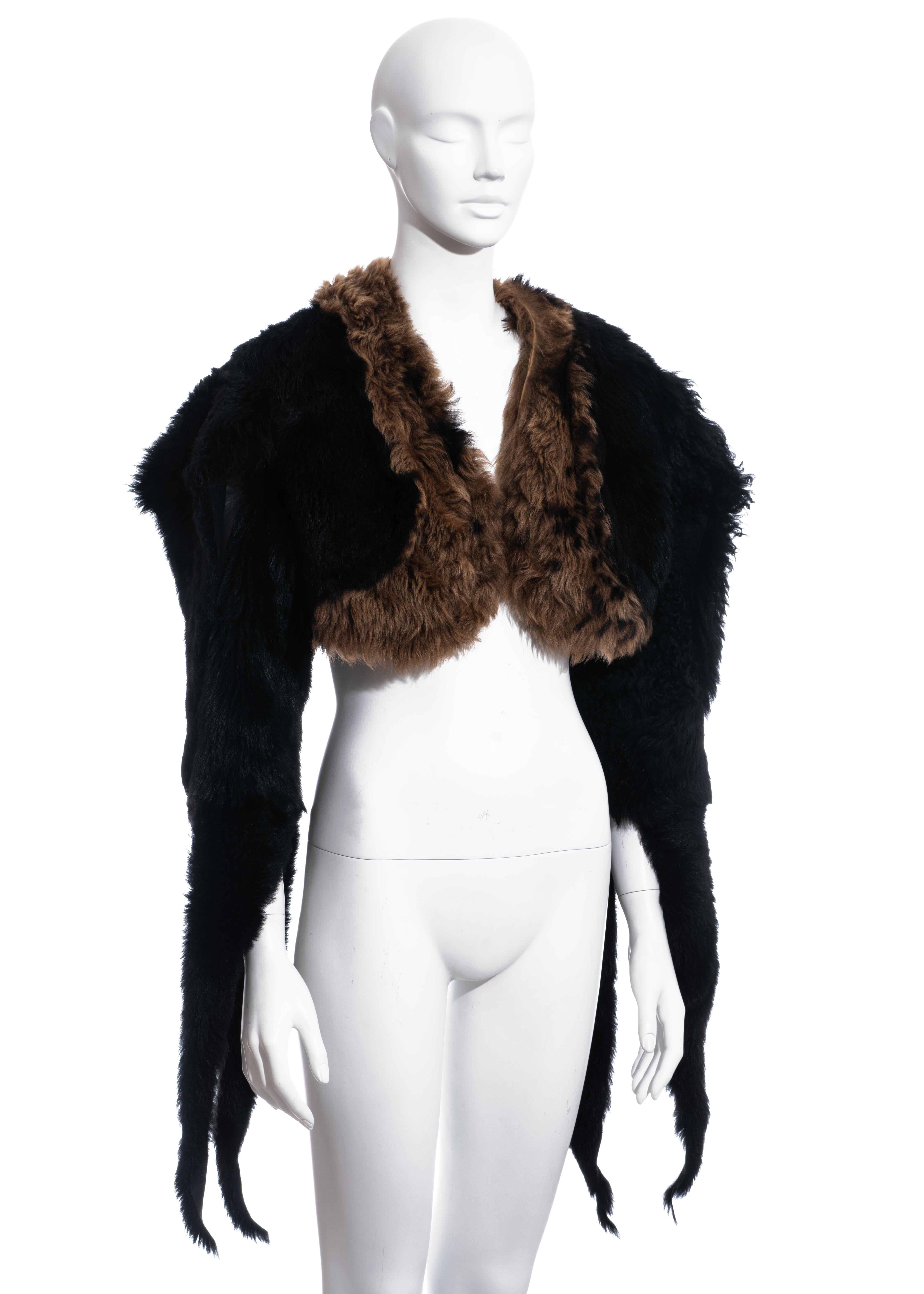▪ Vivienne Westwood fur cropped jacket 
▪ 100% Sheepskin
▪ Wide shoulders 
▪ Natural raw edge 
▪ Sleeves with slits 
▪ Open design with no front closure 
▪ FR 40 - UK 12 - US 8
▪ Fall-Winter 1995
