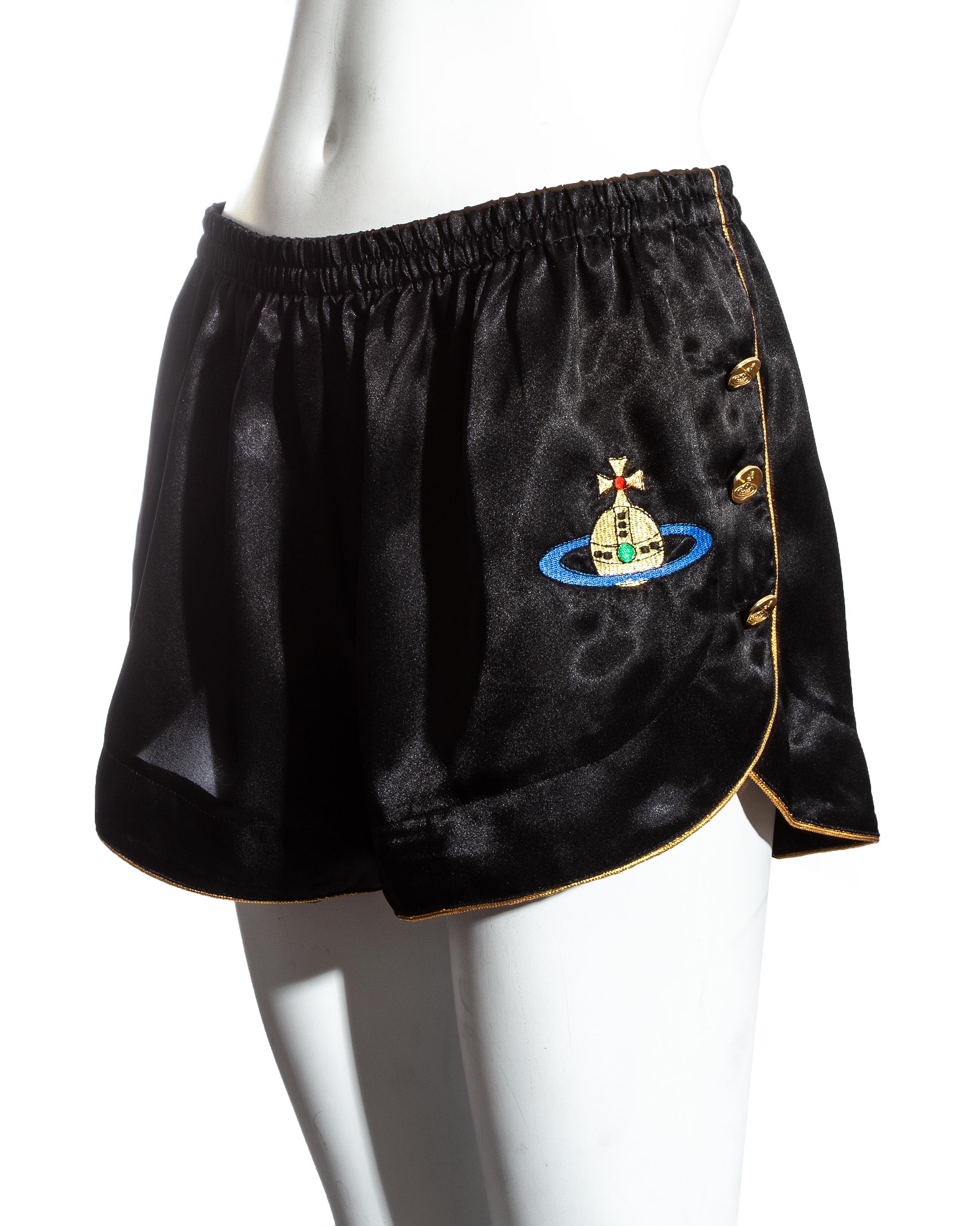 Vivienne Westwood black and gold satin mini shorts with large embroidered orb and 6 westwood gold buttons on side slits.

Spring-Summer 1993